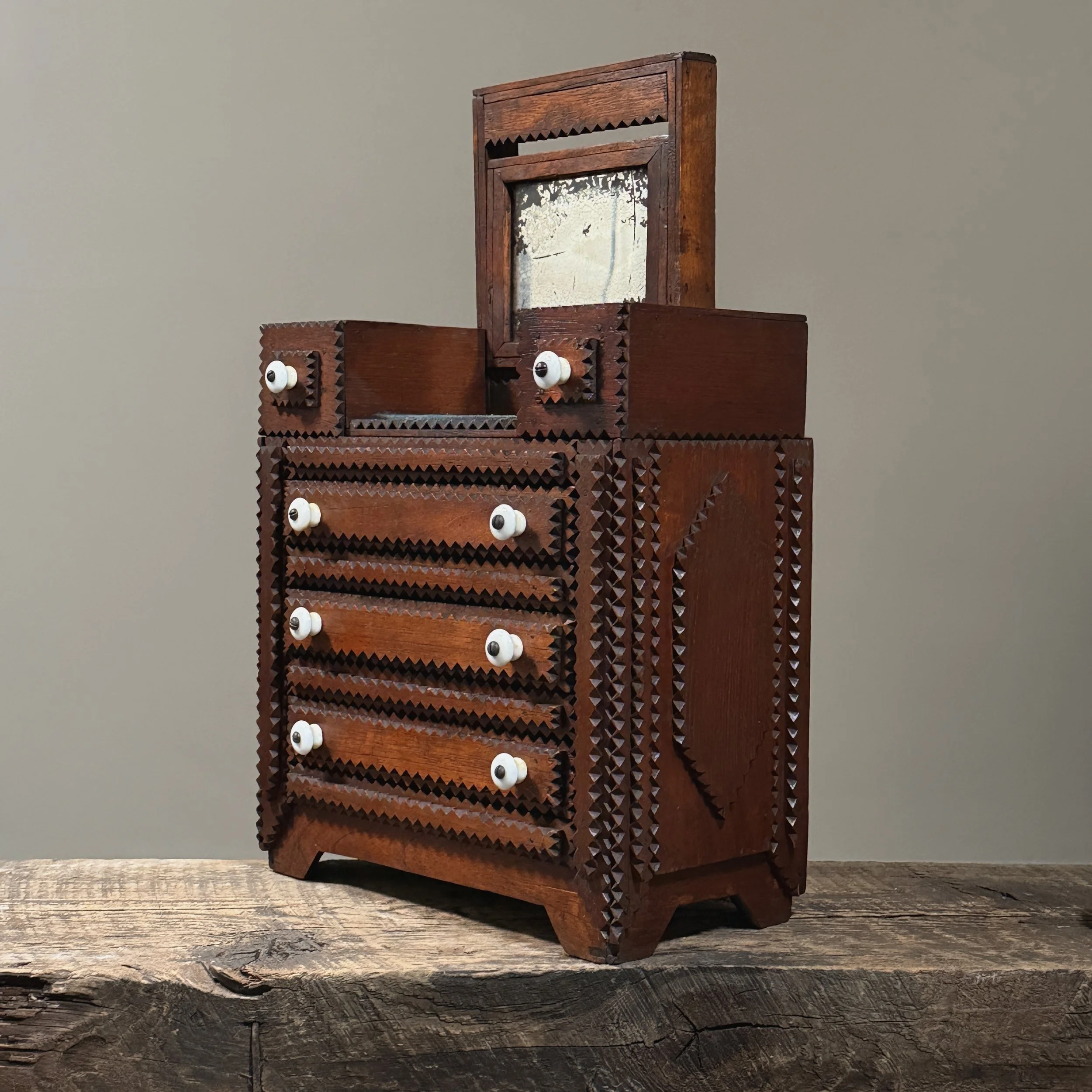 Side of the dresser showing the large, carved geometric shape.