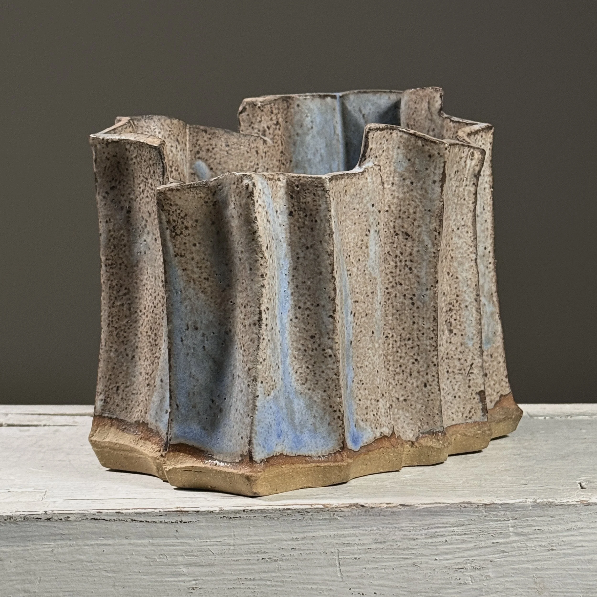 Three-quarter view showing the abstract faceted form.