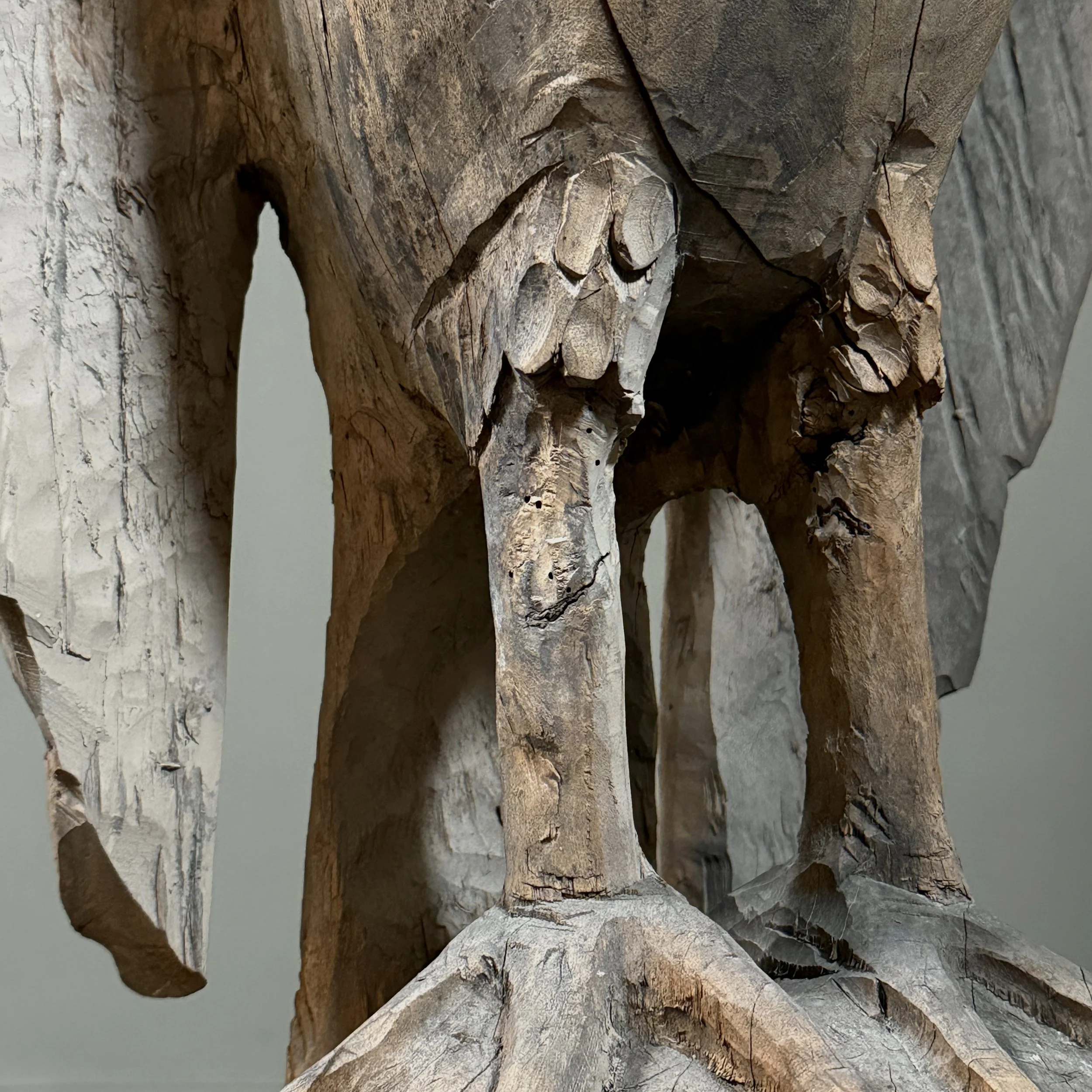 Rustic hand carved bird sculpture aged wood surface