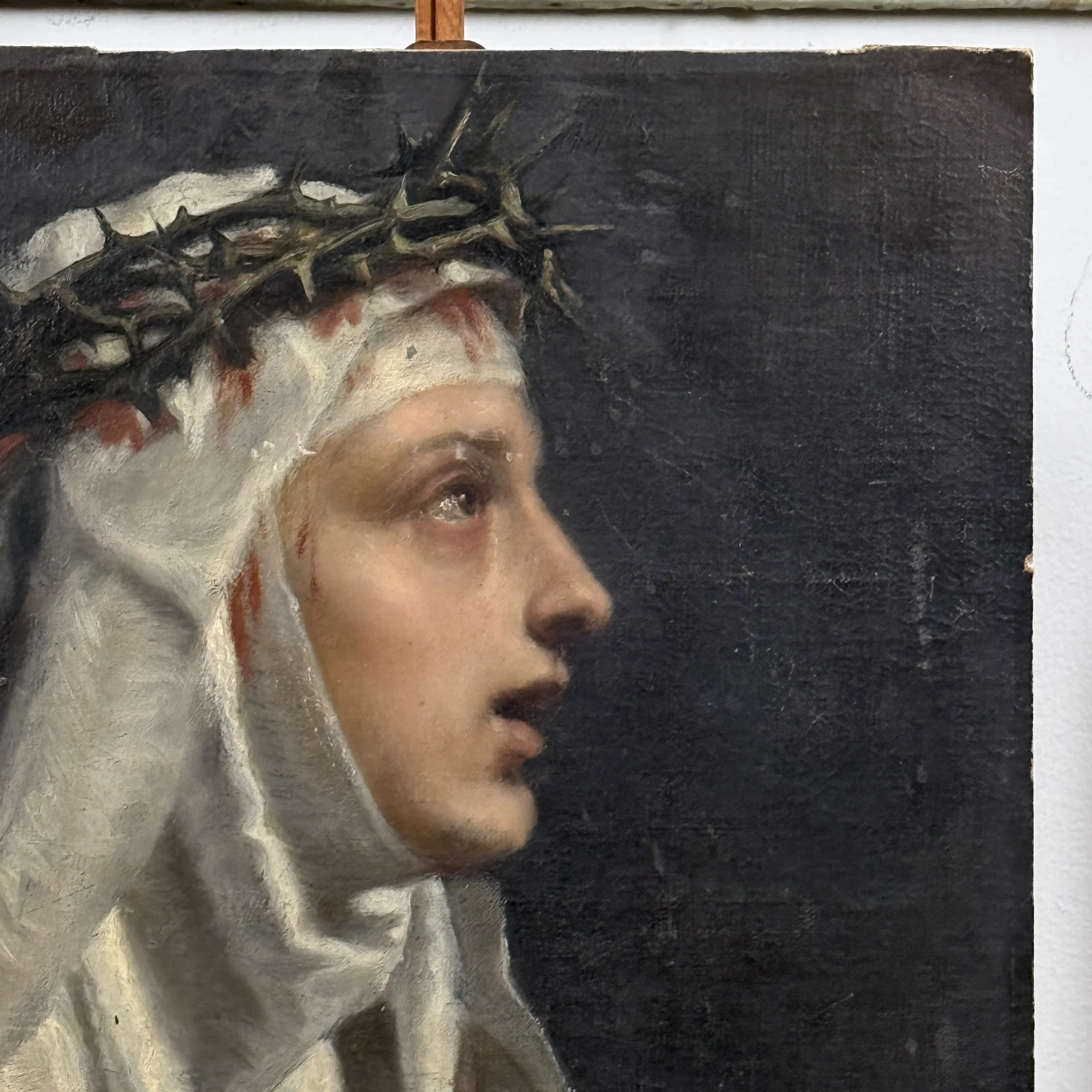 Close-up detail of Saint Catherine of Siena's face and crown of thorns in antique Academic Realist portrait, oil on board