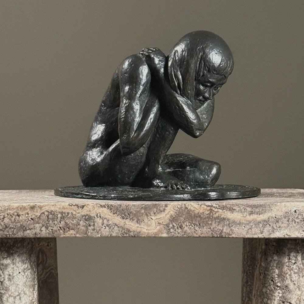 Full frontal view of a vintage realist bronze sculpture of a crouching nude woman by Alma Helbig Hobson