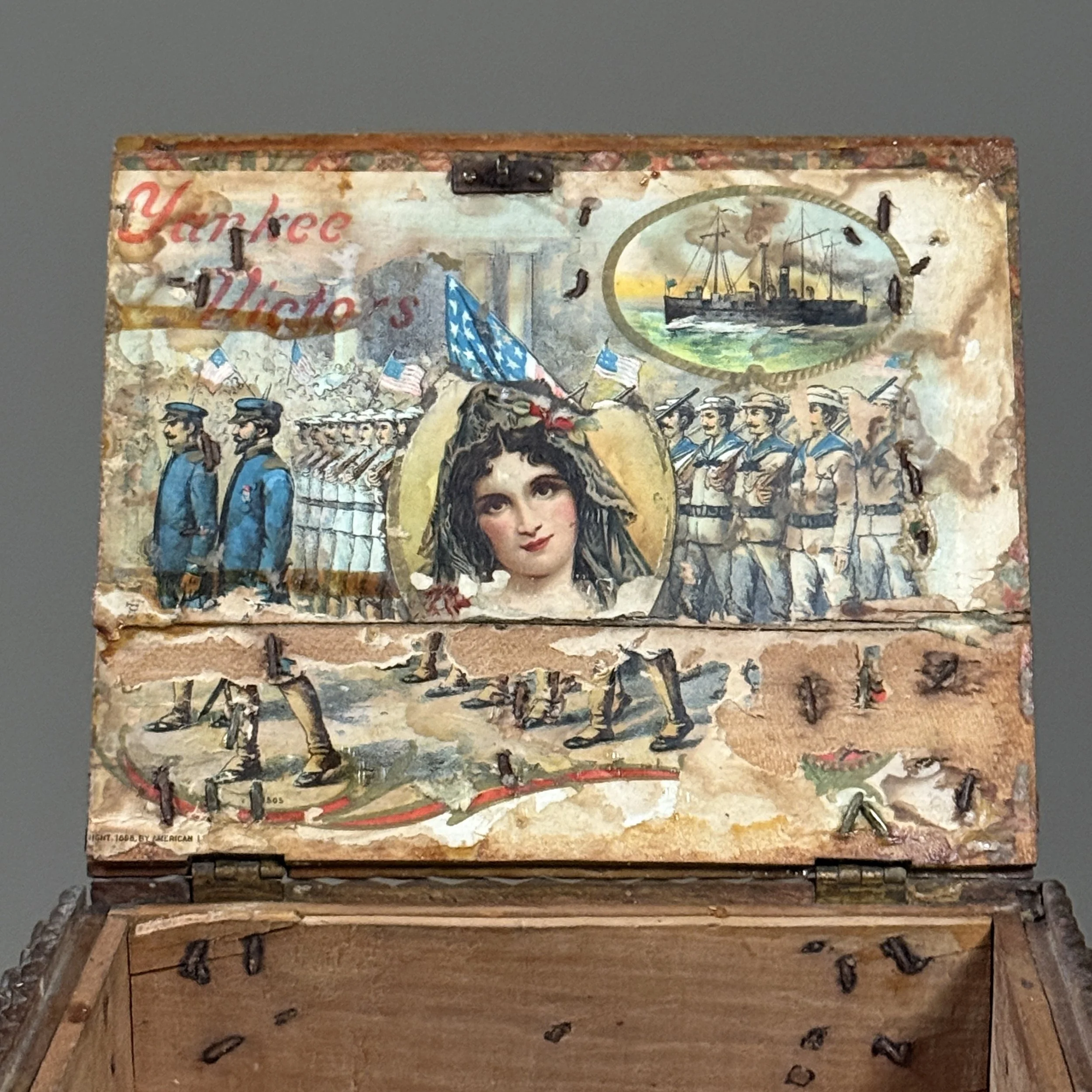 Close-up of Victorian Yankee Victors collage inside tramp art box