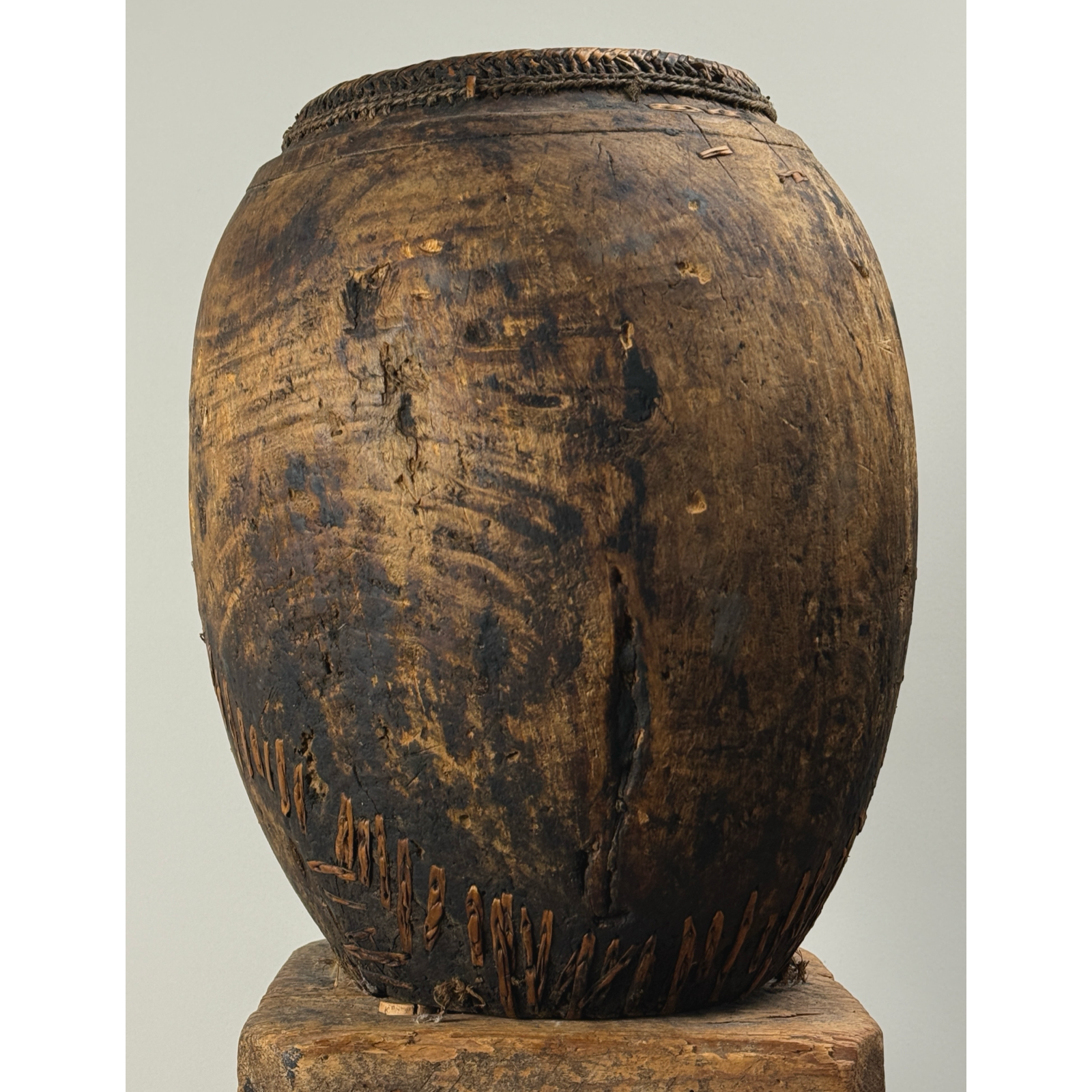 Antique hand carved wooden vessel with woven detail, 15 inches high.