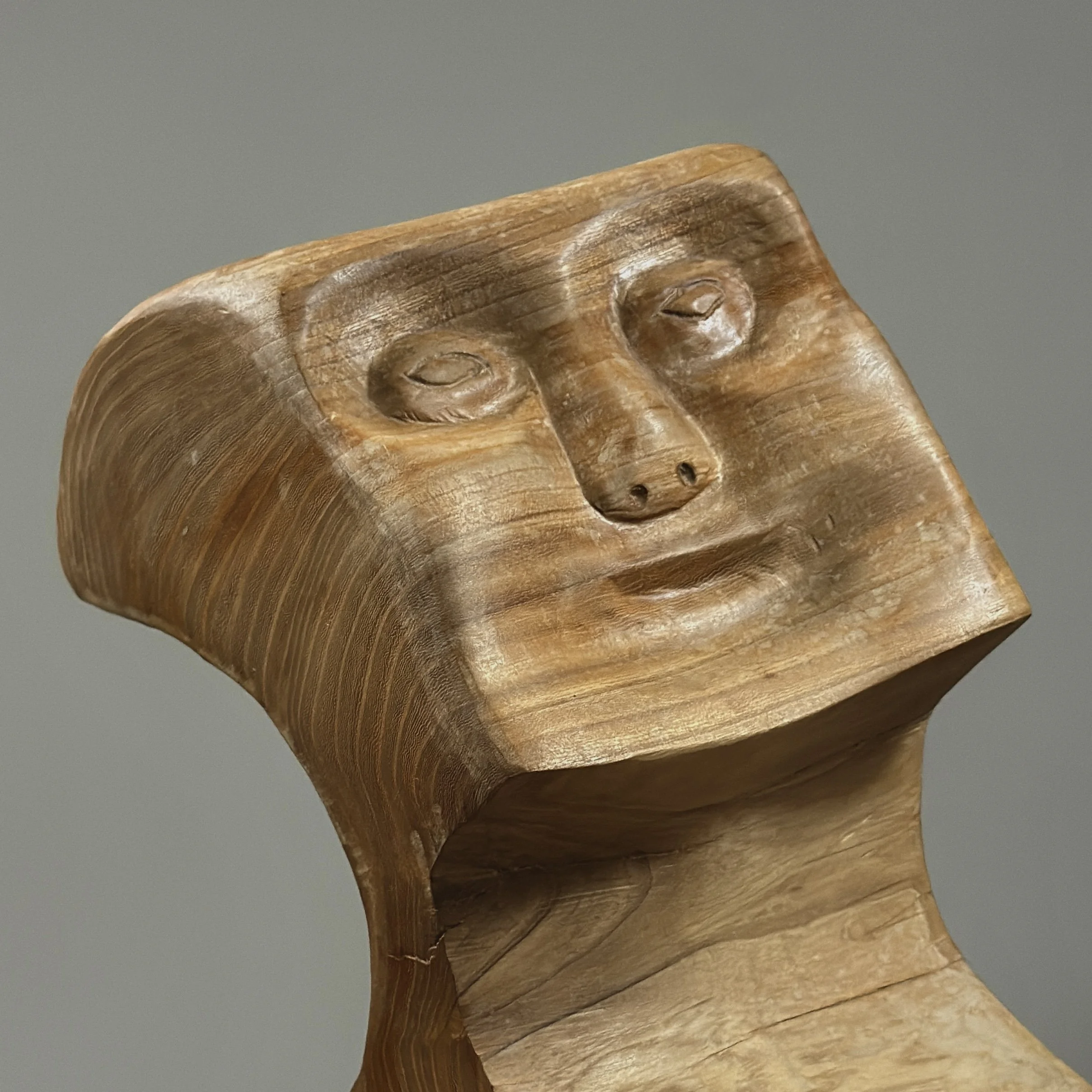 Close-up detail of carved geometric facets on vintage Danish cubist portrait sculpture, hand carved wood