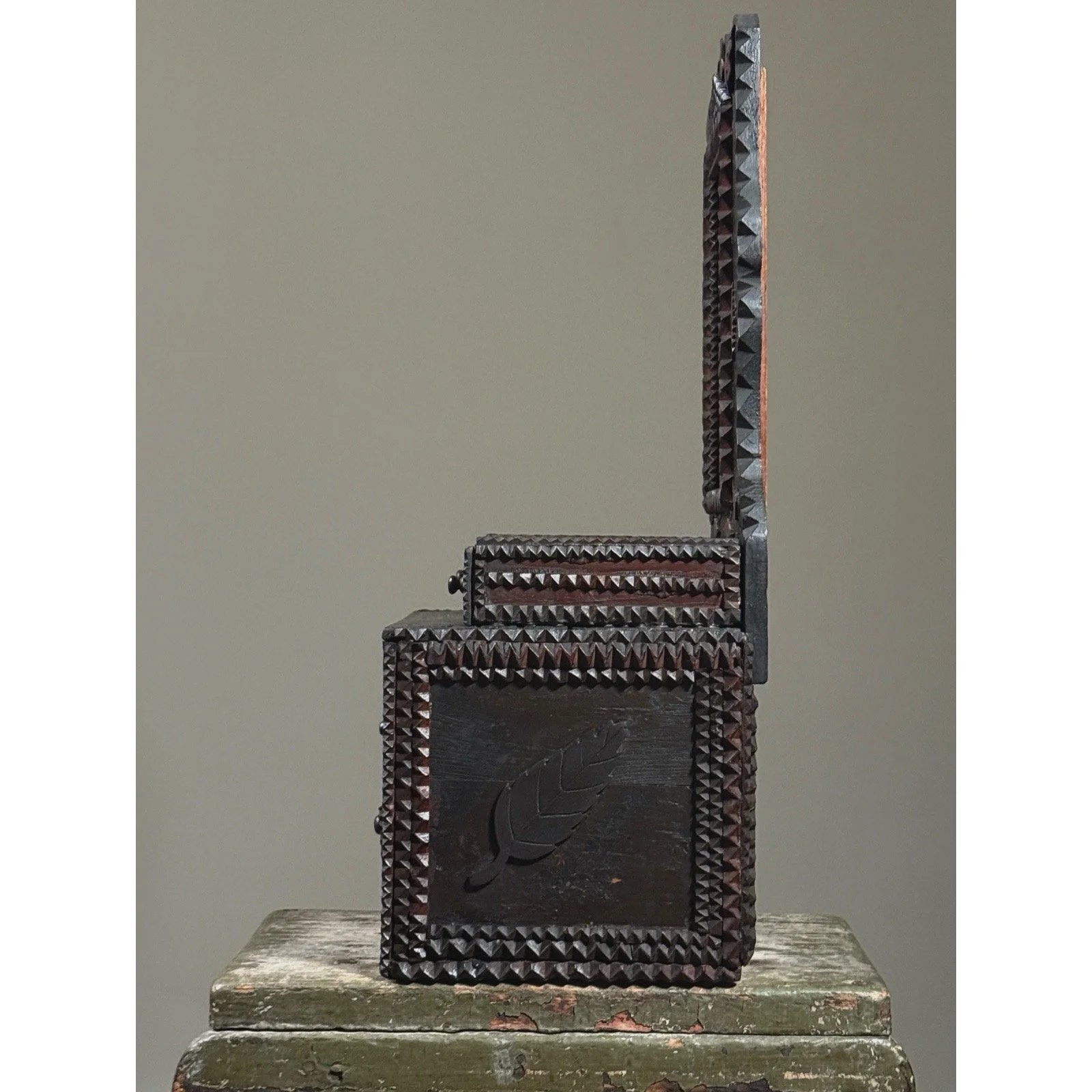 Side view showing the applied chip-carved leaf motif.