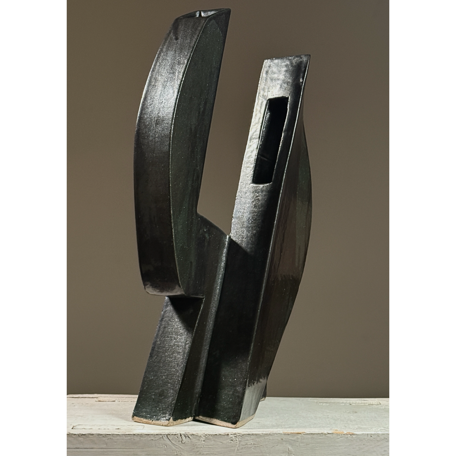 Postmodernist sculptural ceramic ikebana vessel. Glossy black and subtle green glaze. 18.25 inches height.