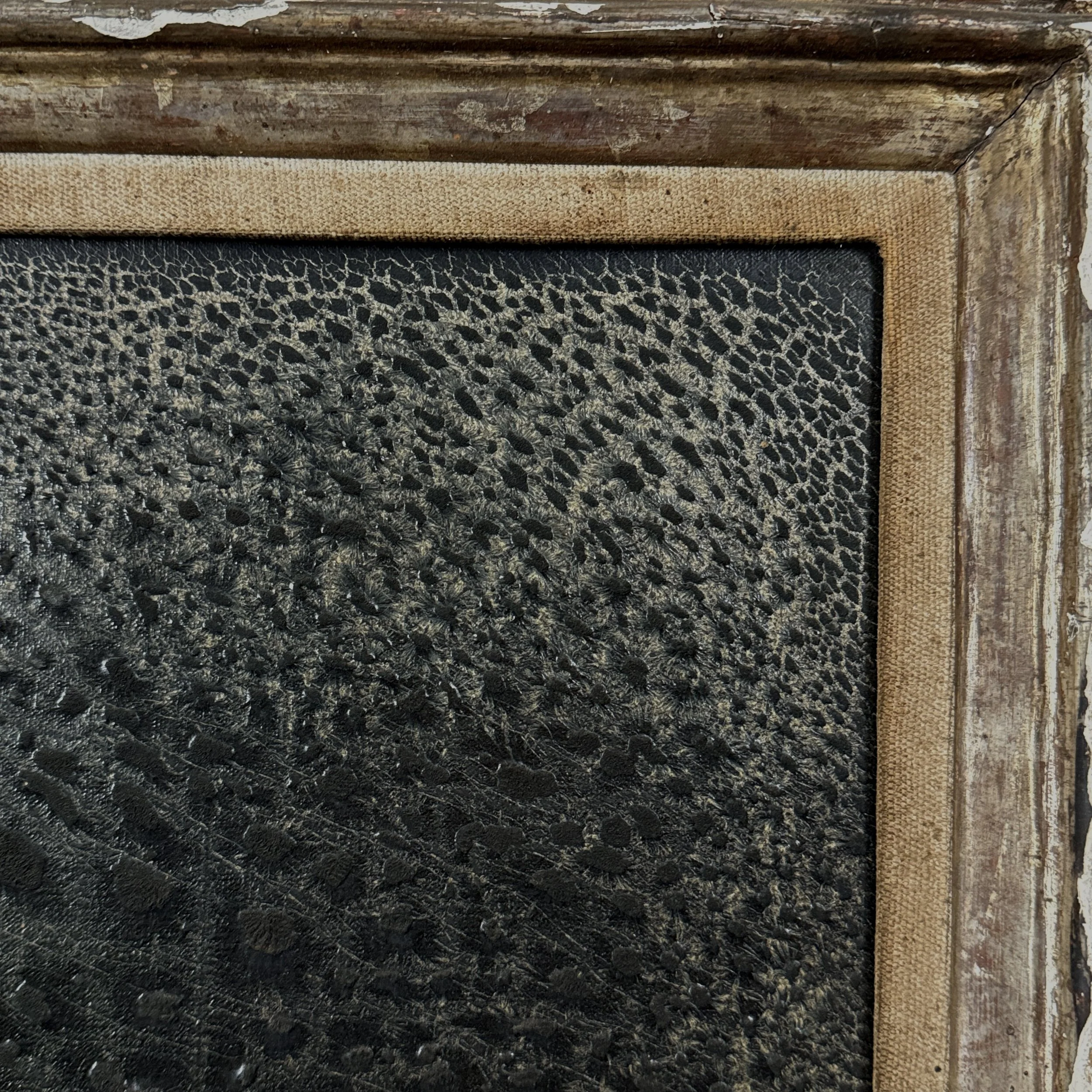 Detail of the frame's corner, showing carving style and losses.