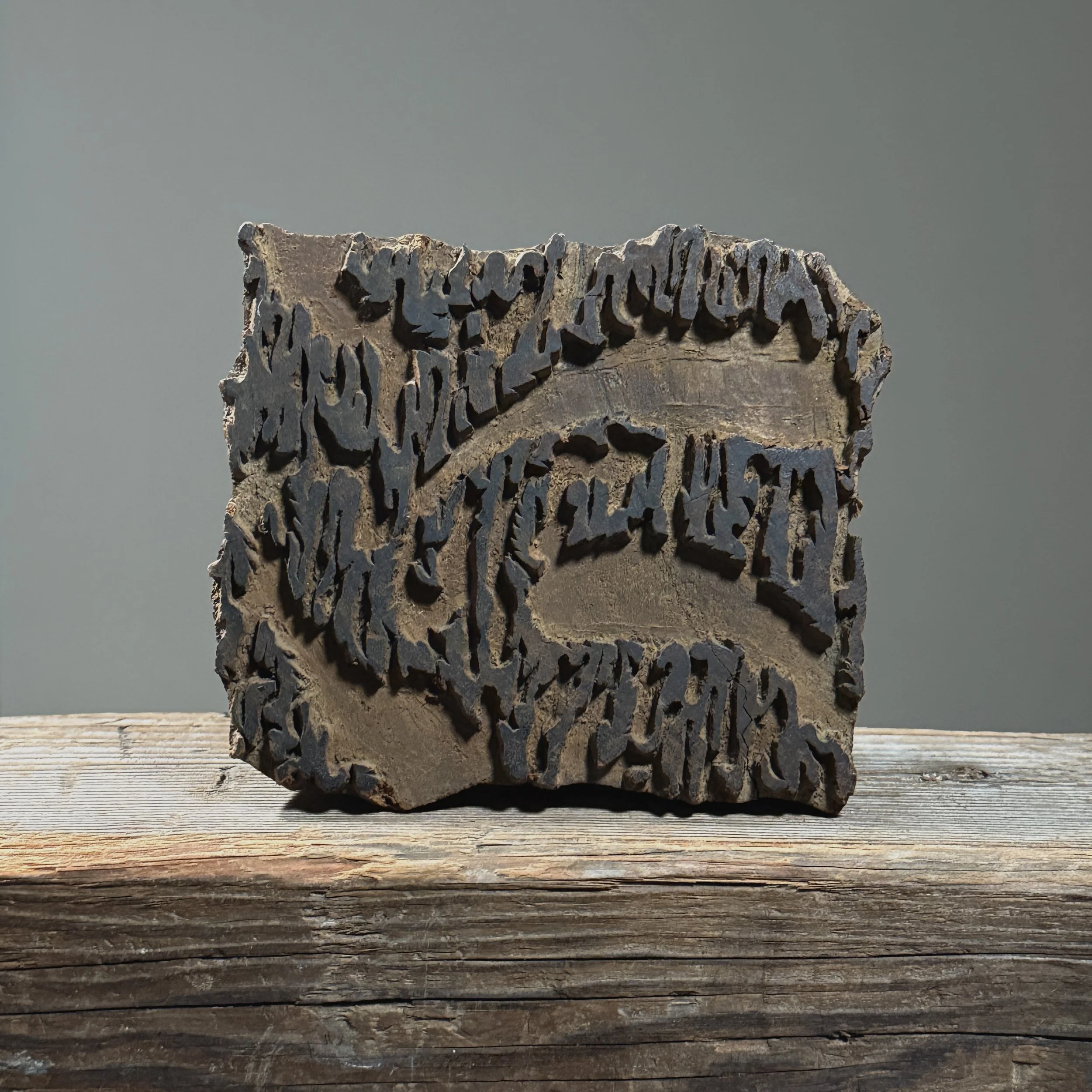 Close-up of the larger printing block showing carved relief design on the printing surface