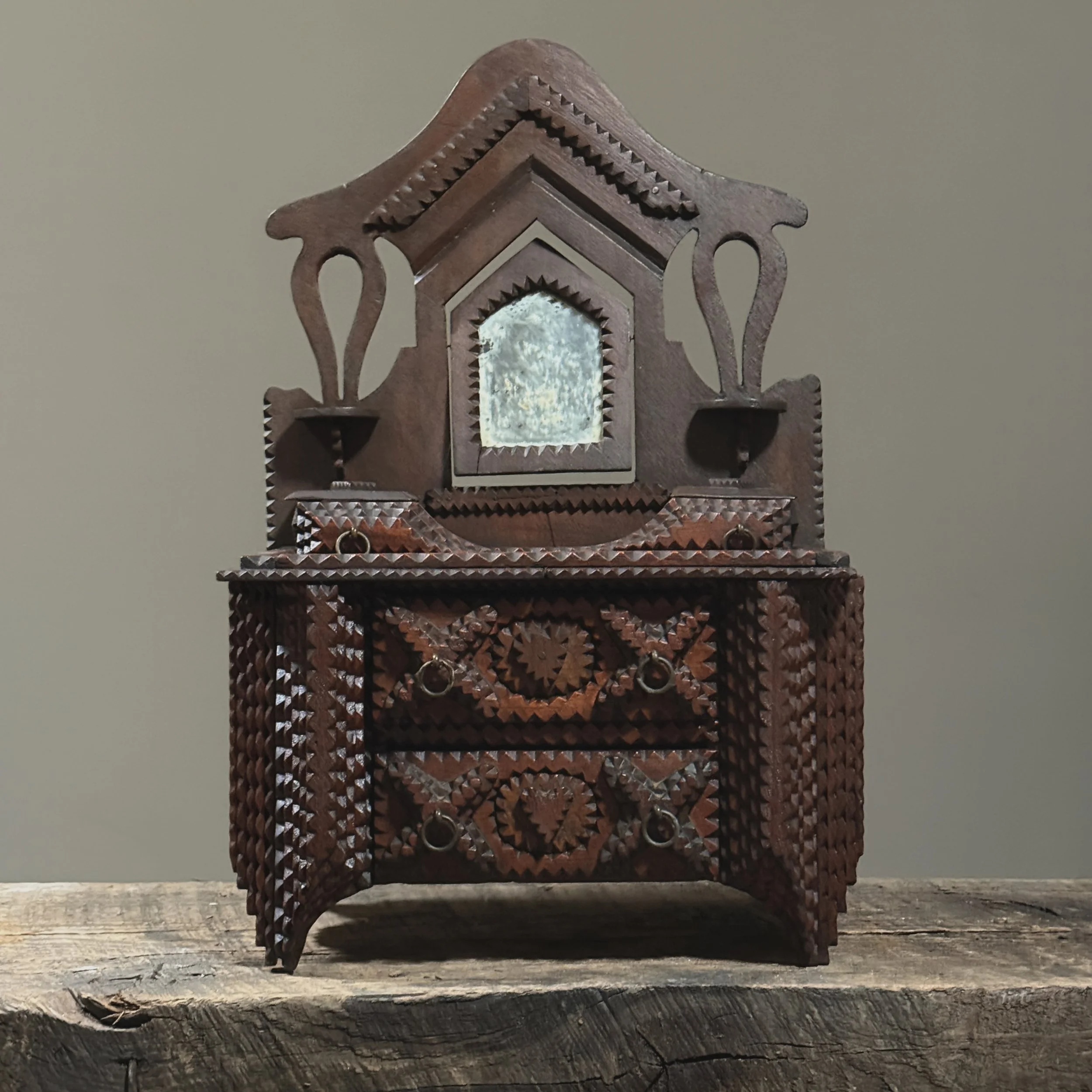 Antique tramp art tabletop dresser with swivel mirror and carved details