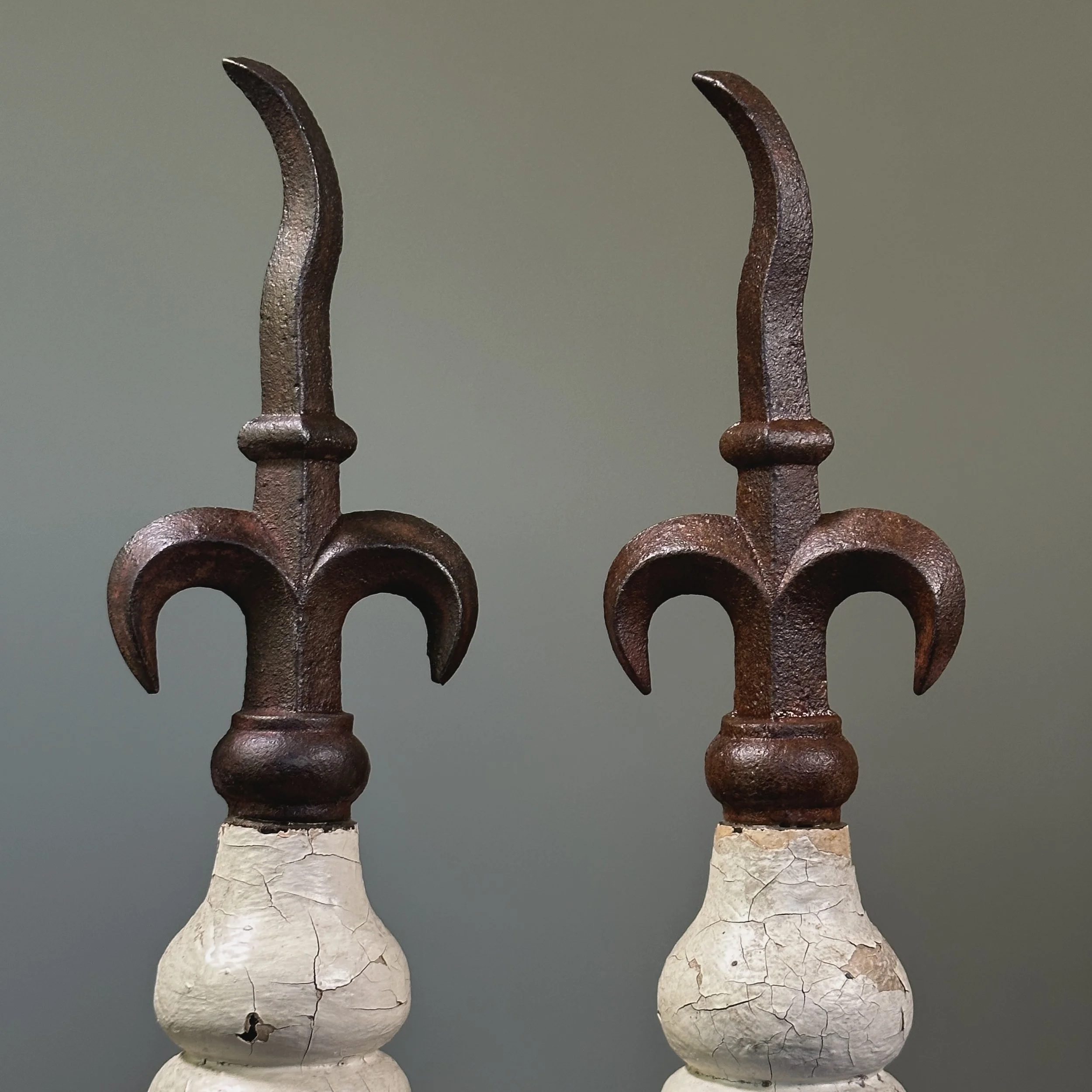 Pair of antique French fleur-de-lis cast iron finials on patinated wood bases
