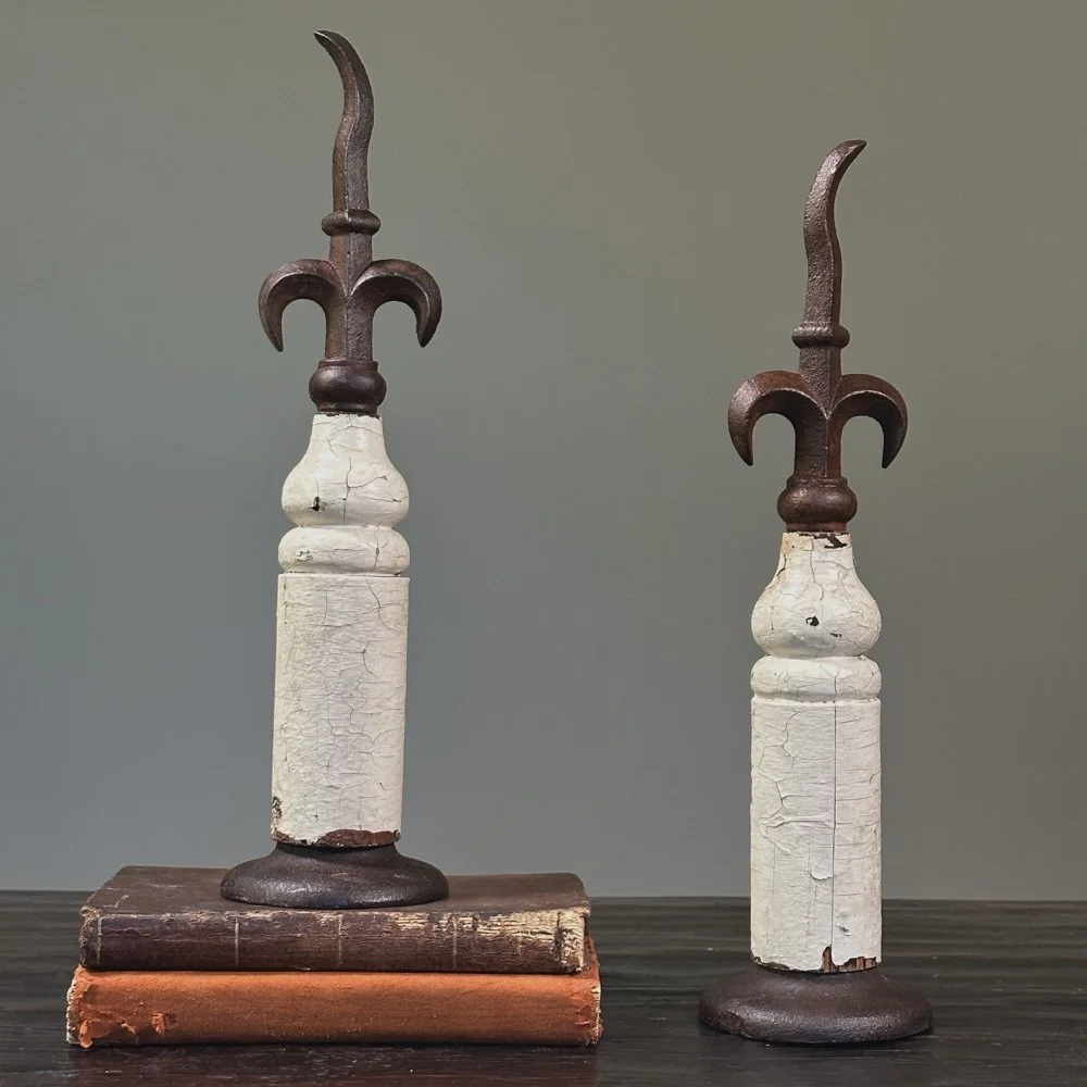 Pair of antique French fleur-de-lis cast iron finials on patinated wood bases