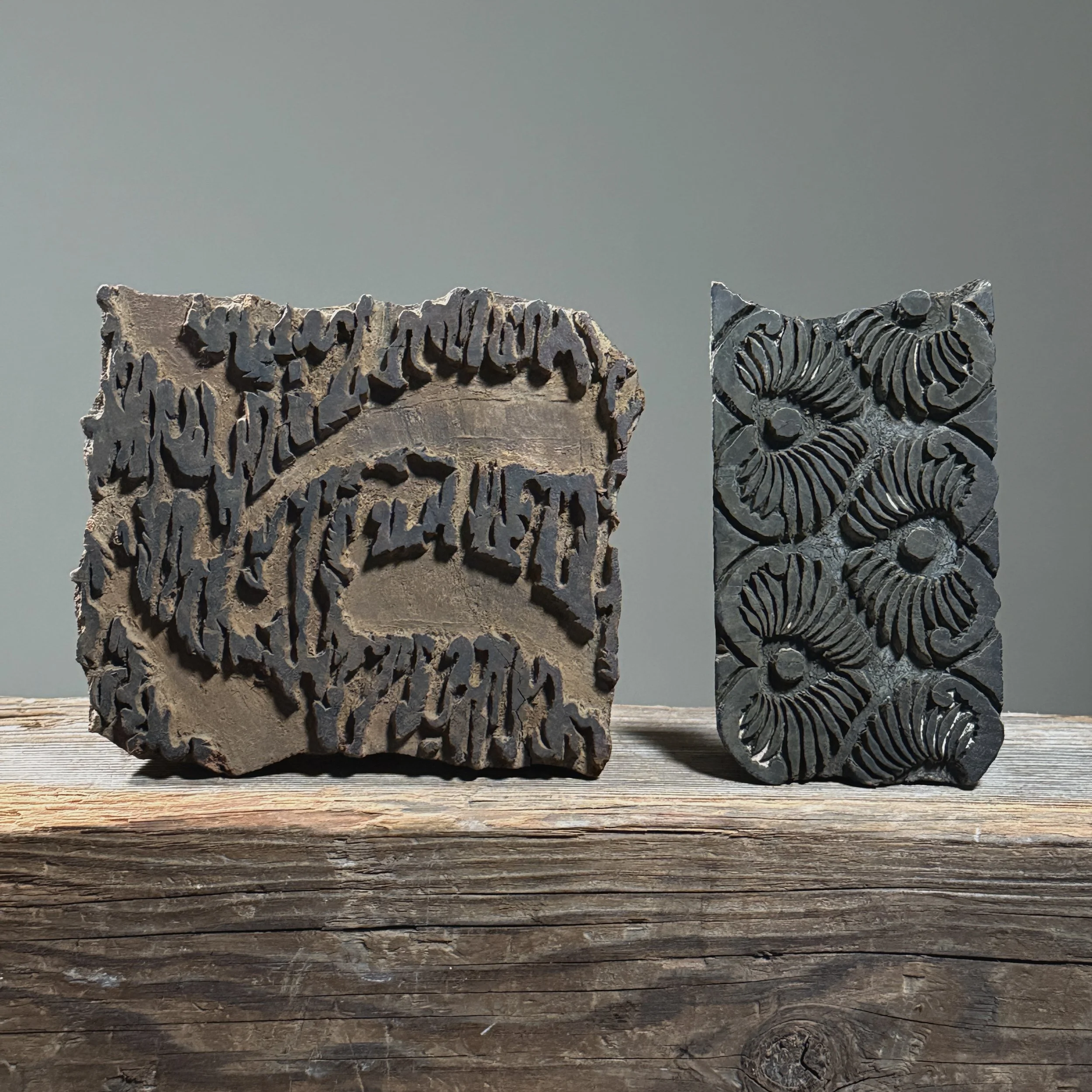 Full frontal view of an antique pair of hand-carved Indian wooden textile printing blocks