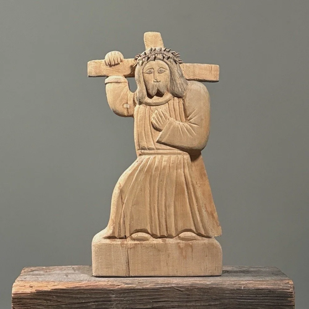 Front view of a vintage Polish hand-carved Stations of the Cross sculpture depicting Christ carrying the cross.