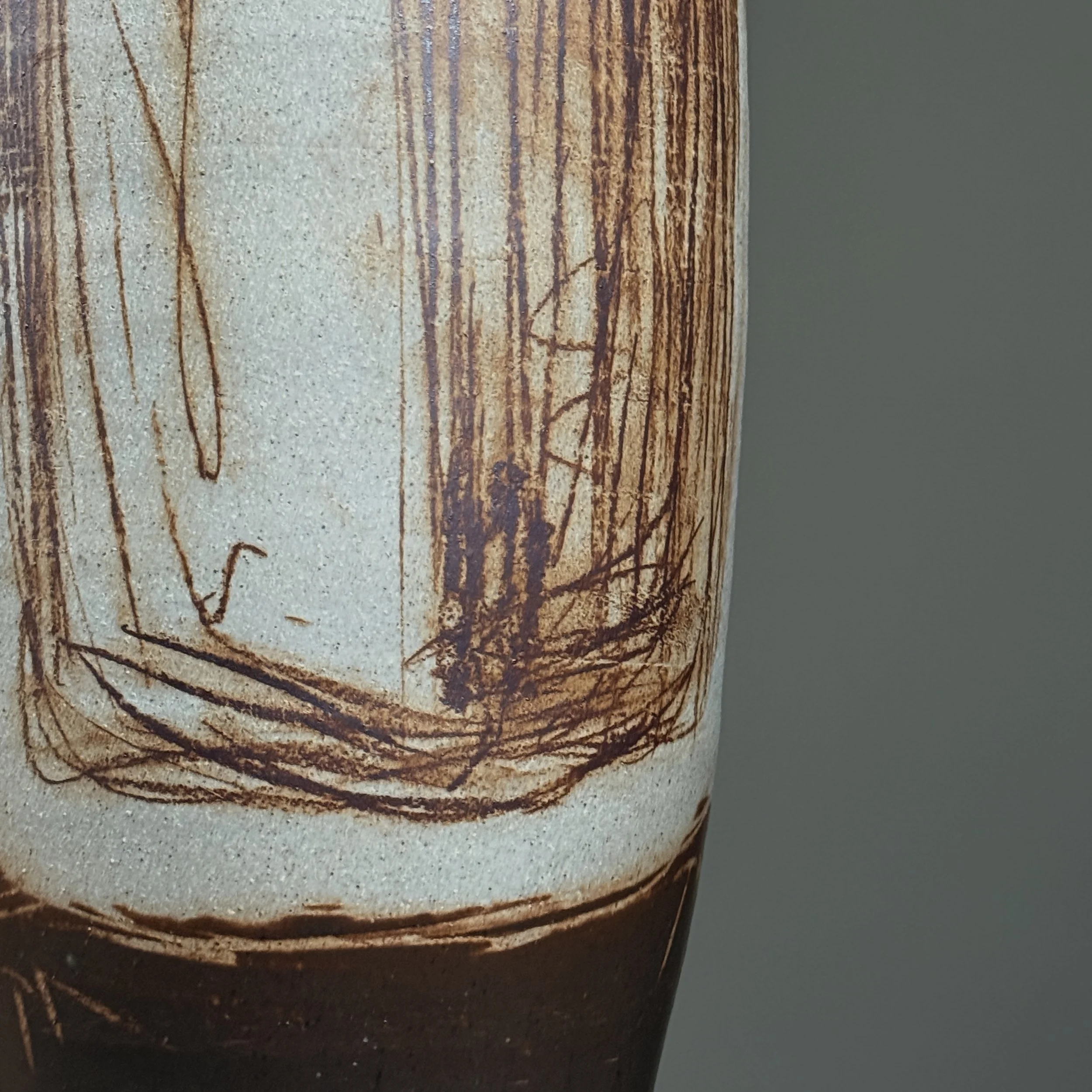 Sculptural tall ceramic vessel with artistic detailing