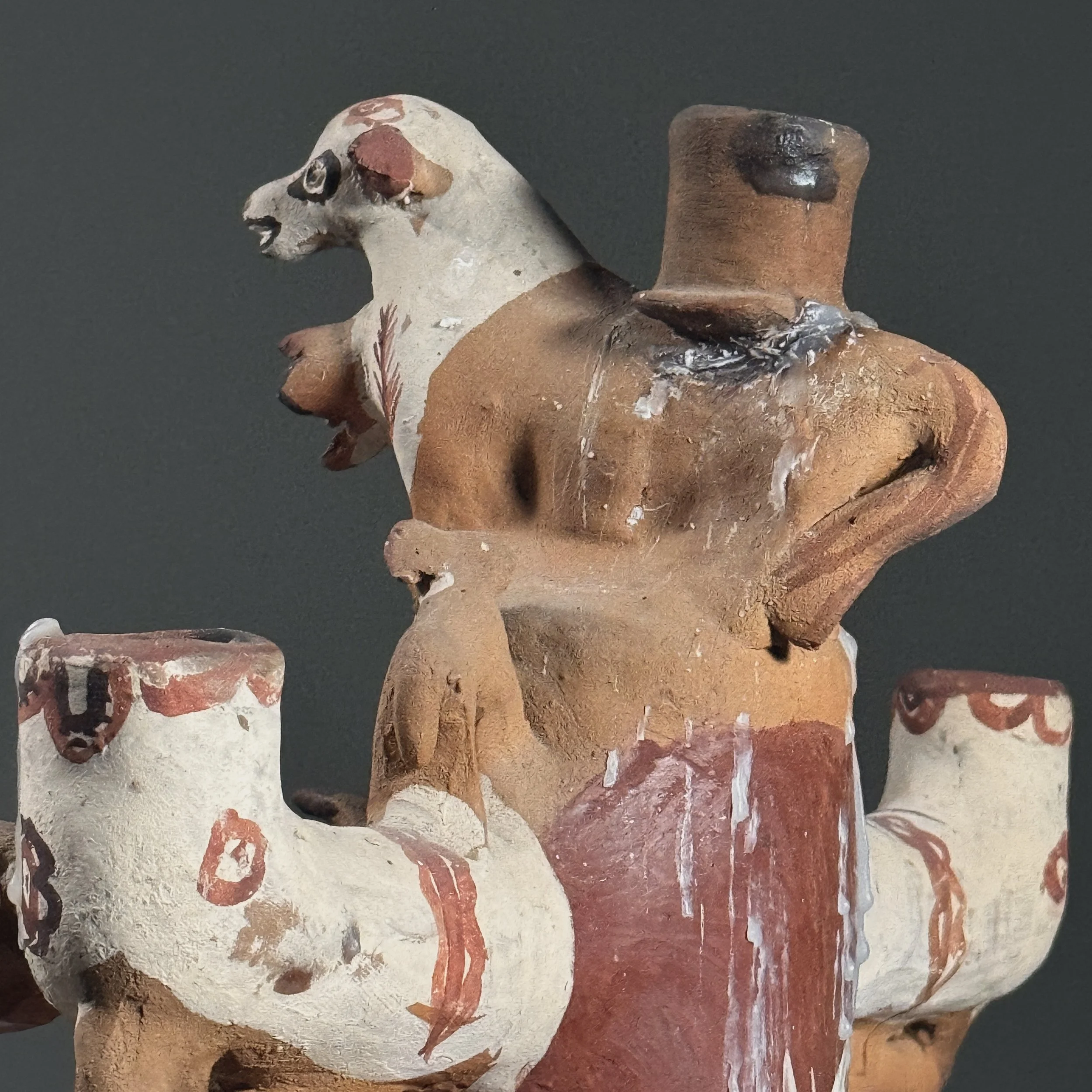 Detail of the top candle holder and surrounding figural decoration