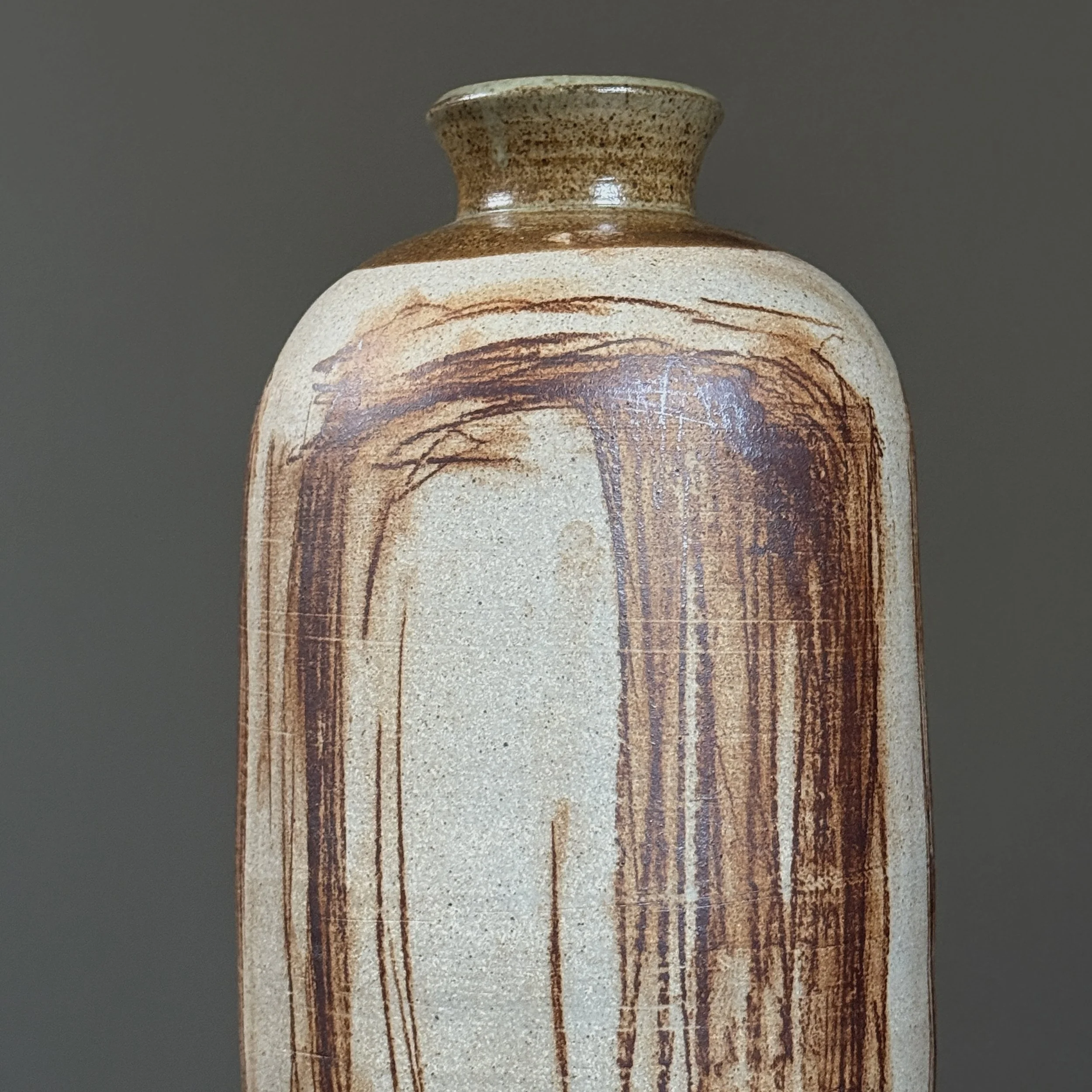 Close-up of brown abstract markings on vintage ceramic