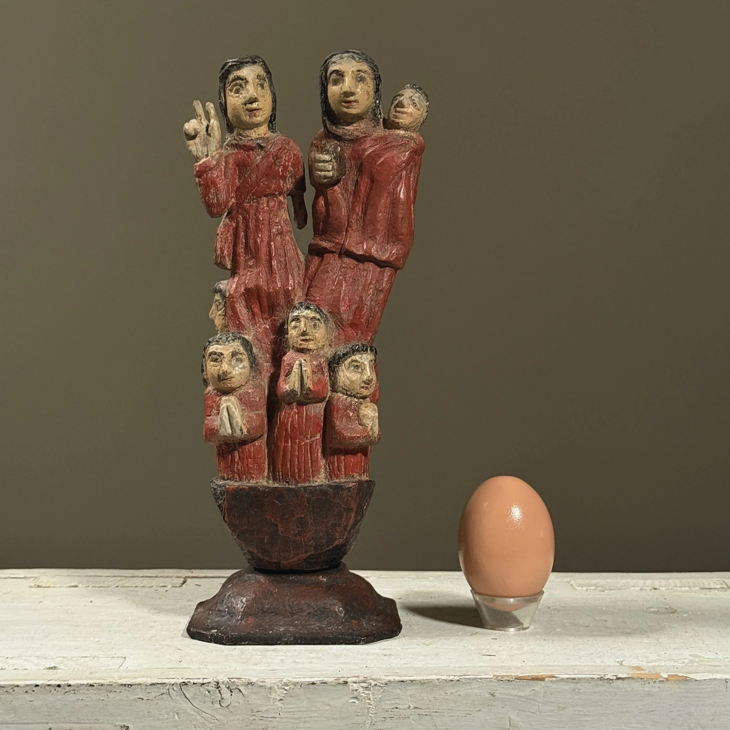 Spanish Colonial devotional carving showing man, woman, and children with egg for size reference.