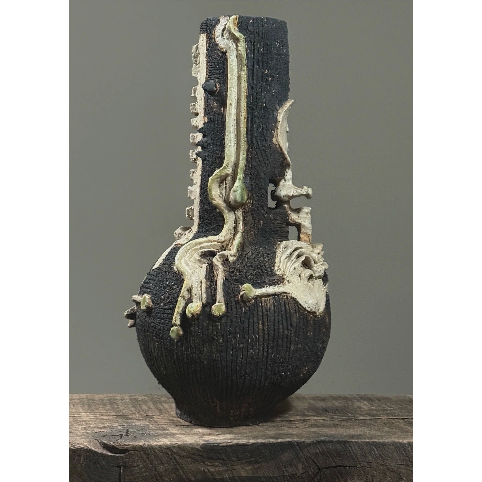 Unsigned Brutalist vessel with applied skeletal elements and Raku finish
