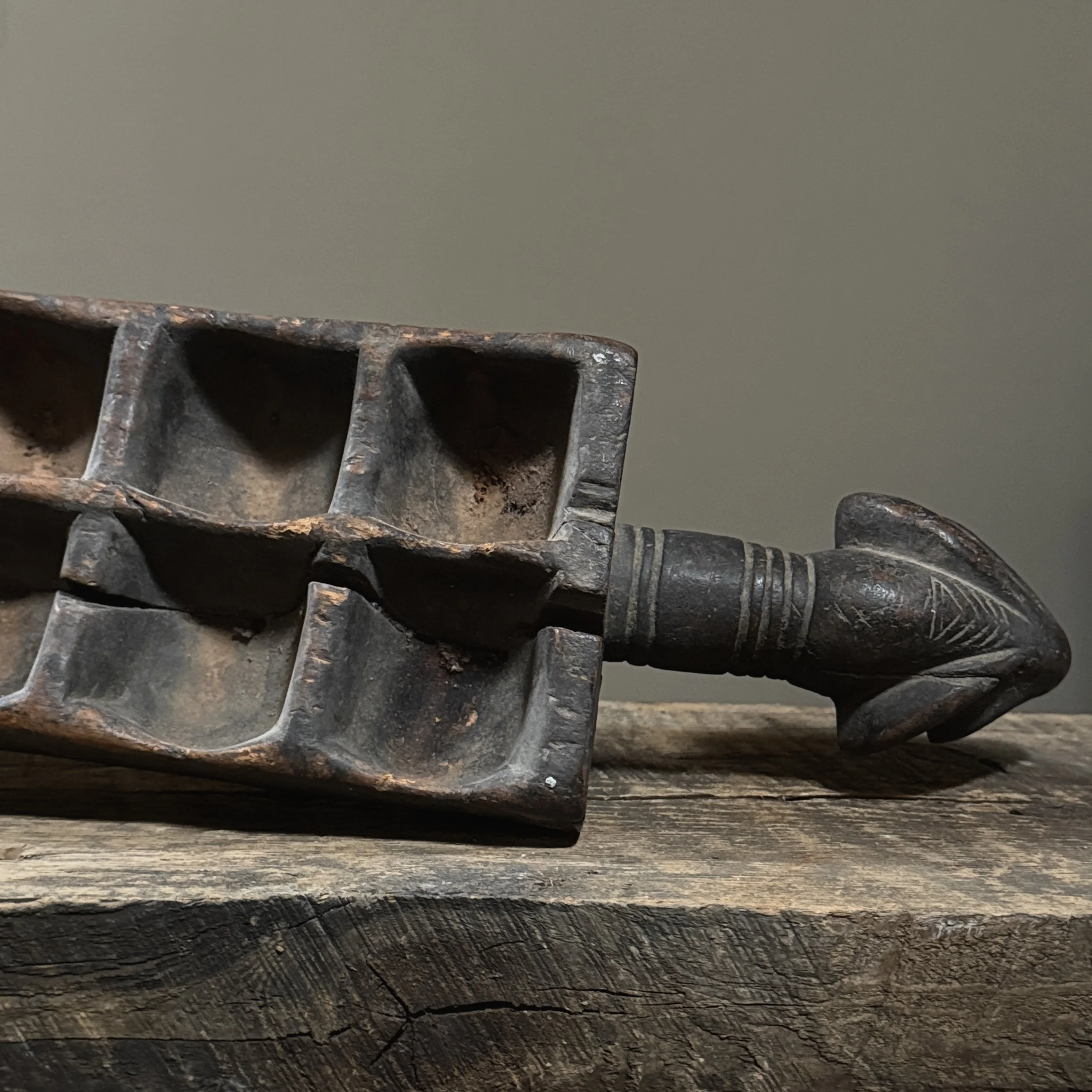 Carved African folk art object combining sculpture and game board design