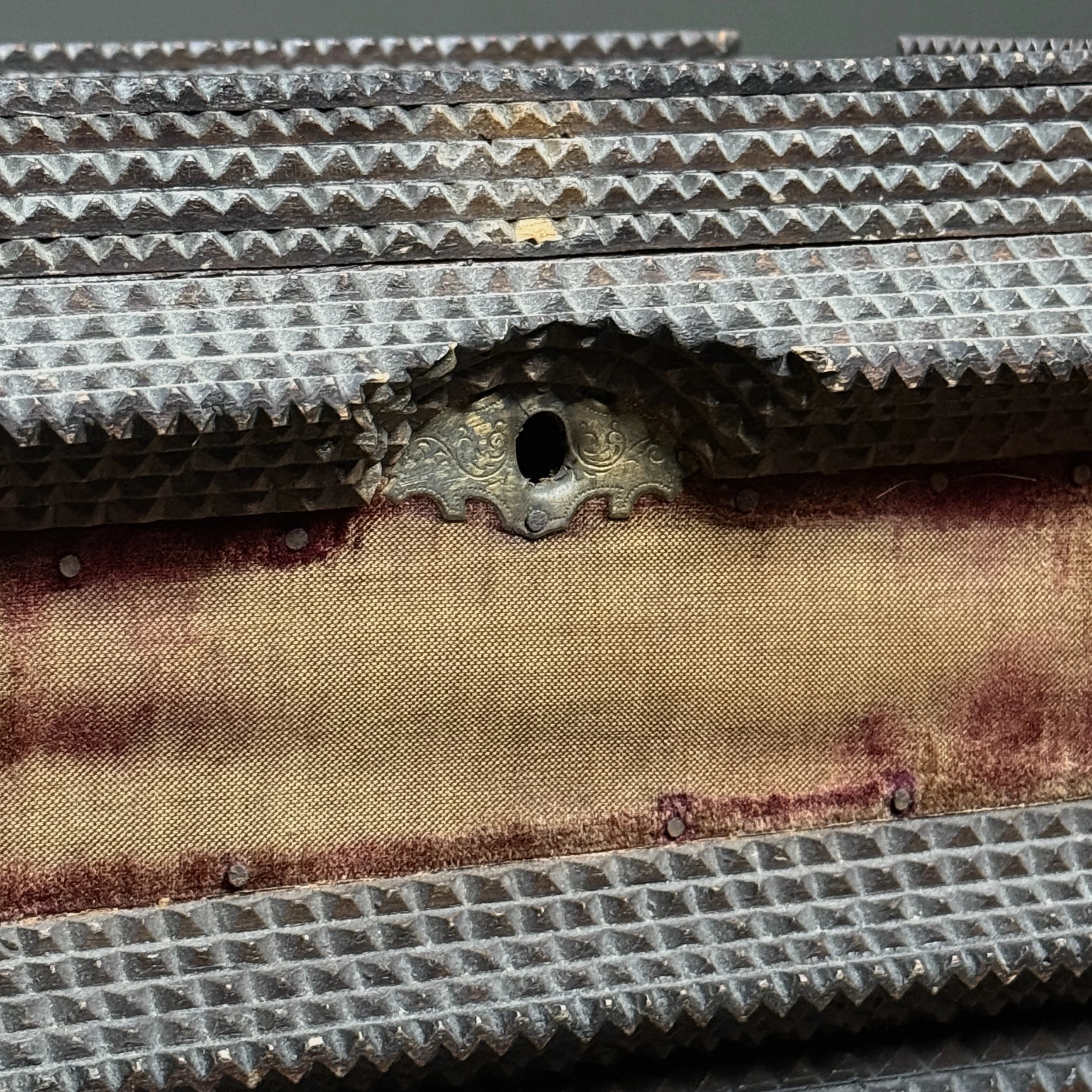 Detail of the keyhole on the front of the box.