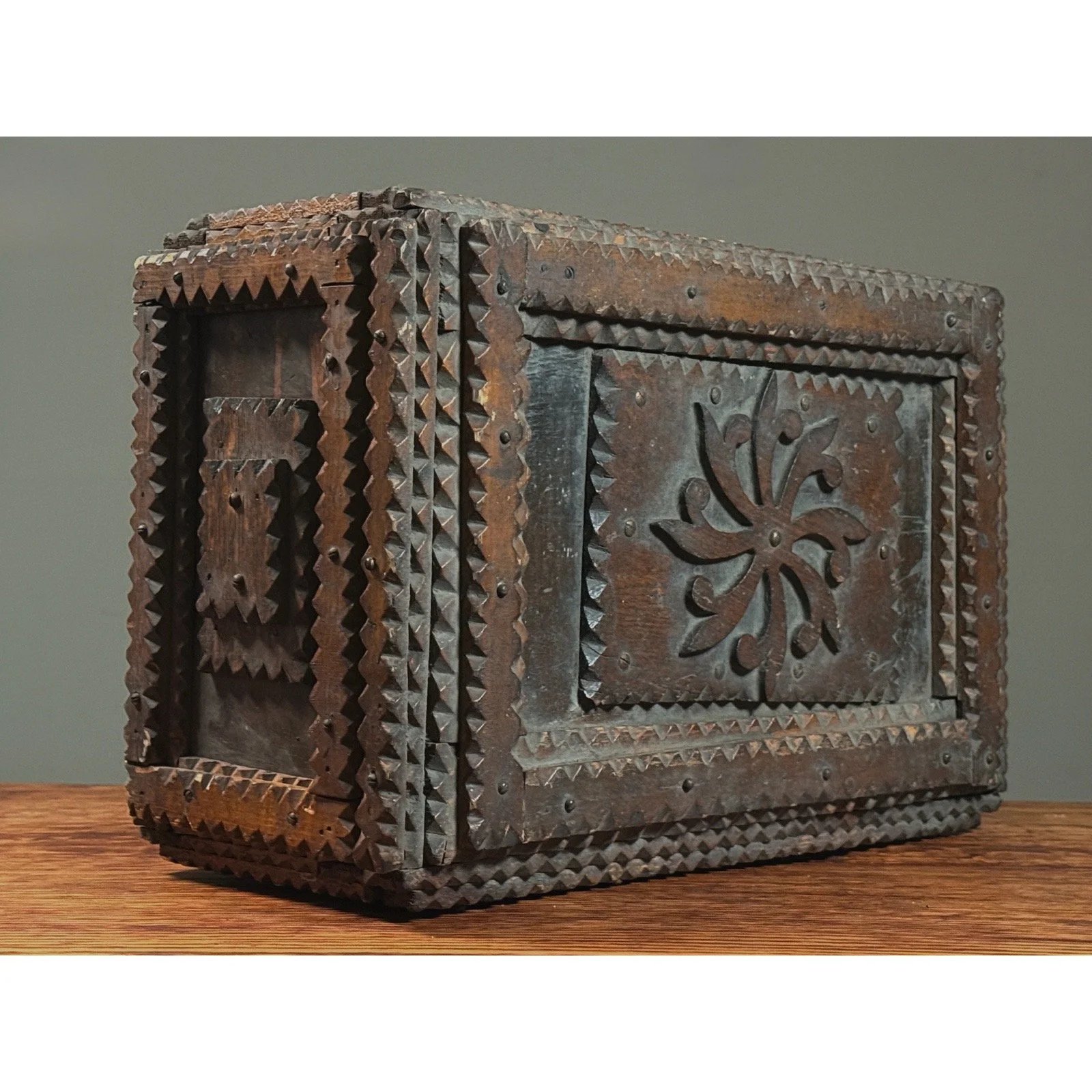 Monumental antique tramp art chip-carved chest, front three-quarter view.