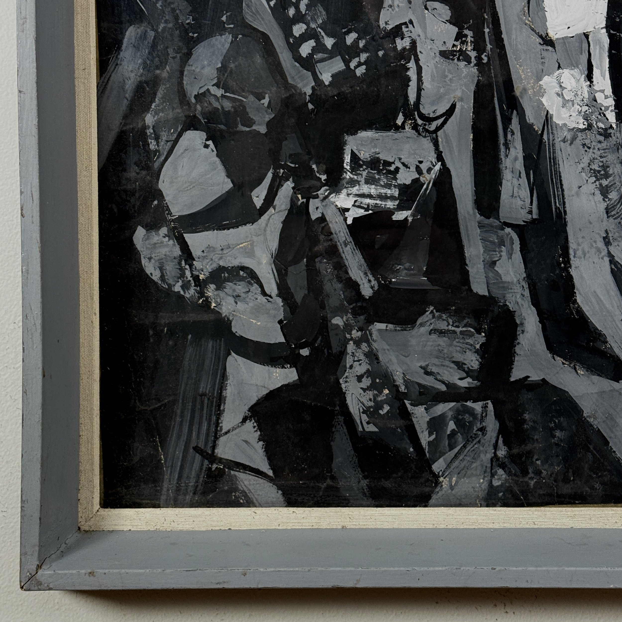 Detail of a corner where the paint, cardboard, and frame meet.