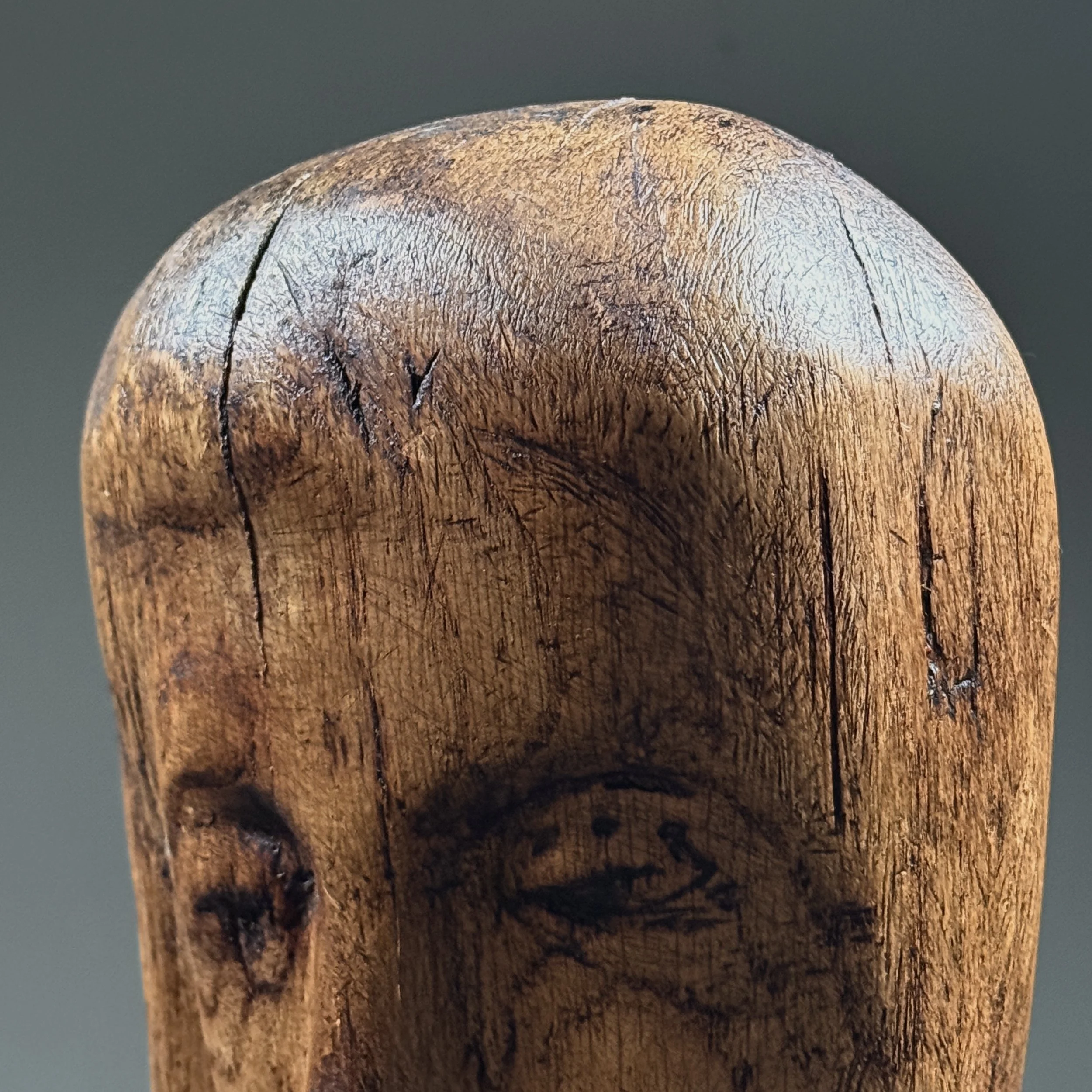Close-up detail of face and carving on vintage hand carved Folk Art Modernist portrait bust, wood