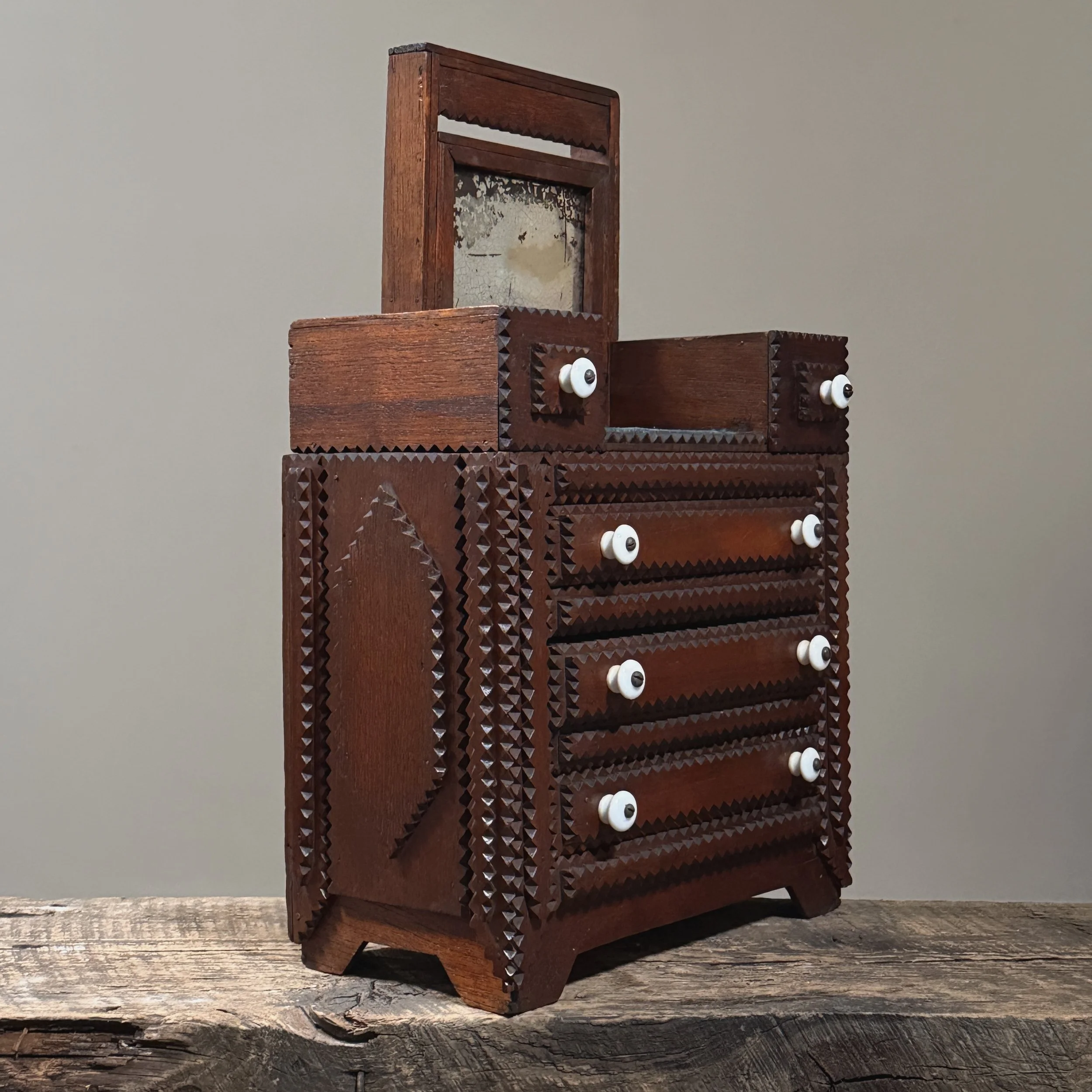 Side of the dresser showing the large, carved geometric shape.