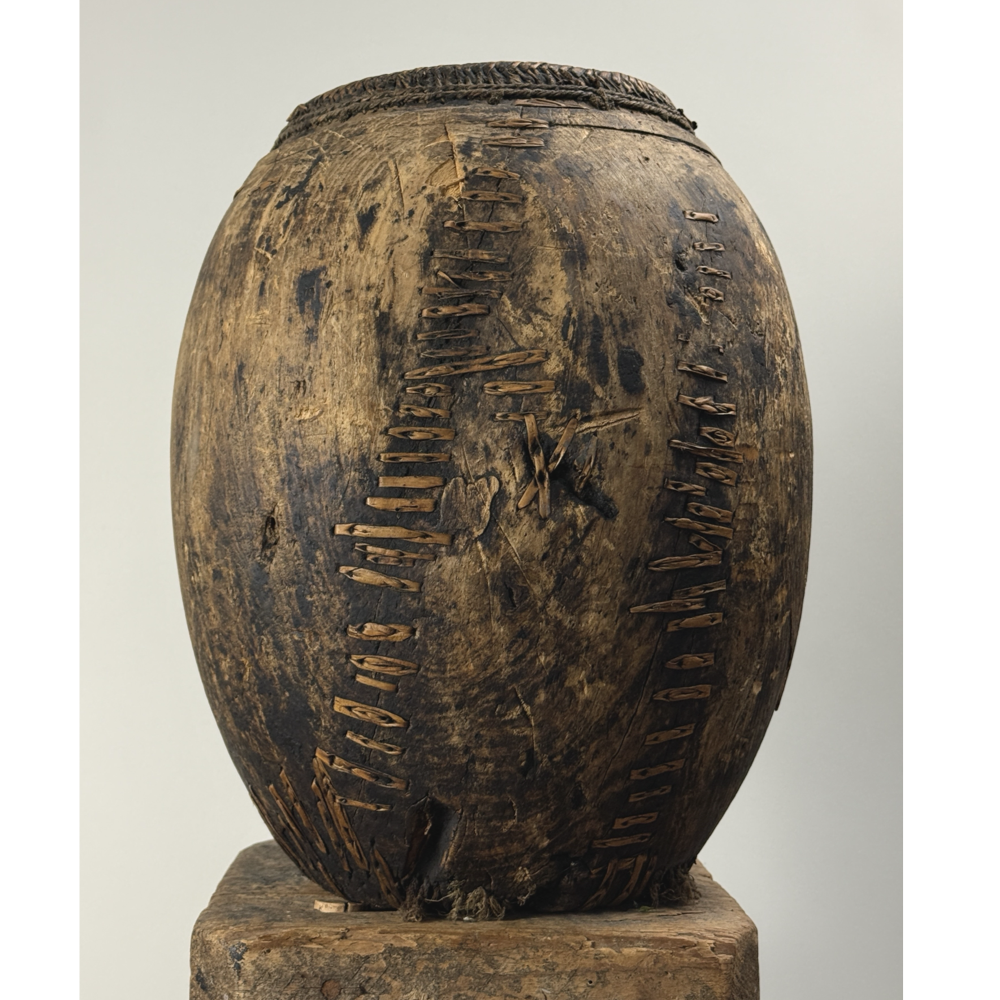 Antique hand carved wooden vessel with woven detail, 15 inches high.