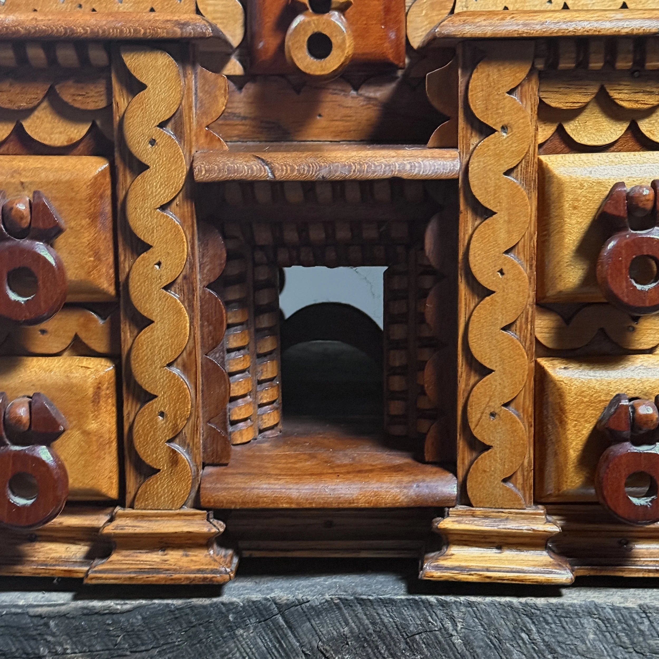 View of the pass-through aperture at the base of a vintage decorated storage box