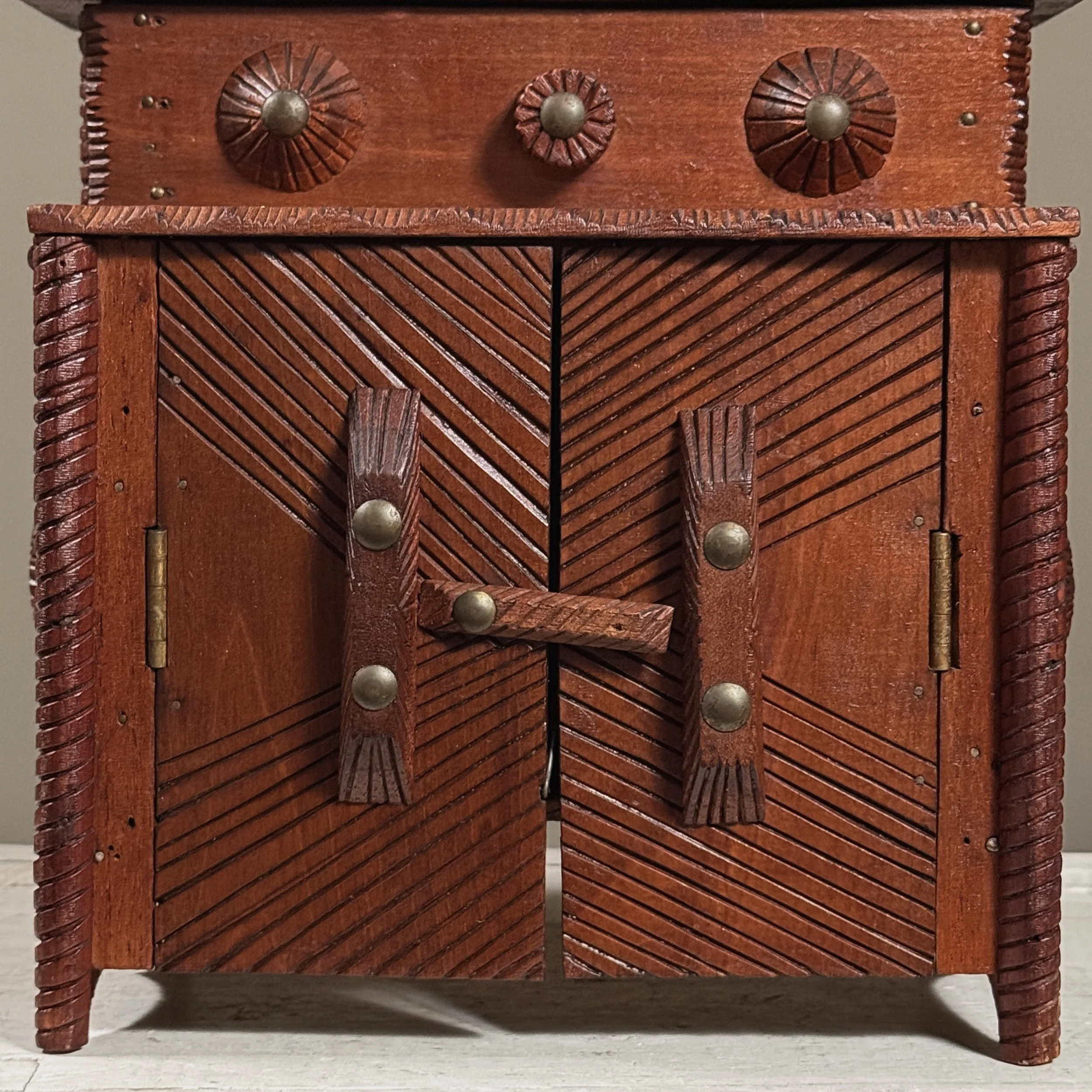 Close-up of carved doors with detailed wooden pulls