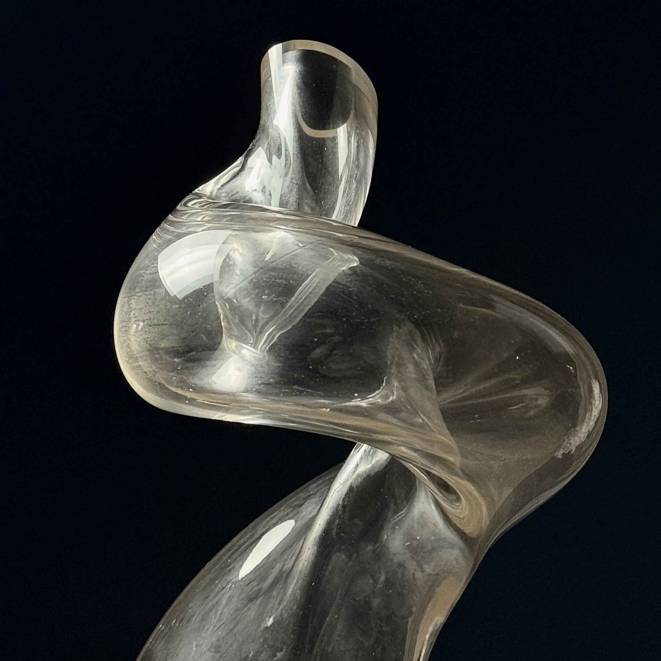 Side profile of postmodern biomorphic glass sculpture highlighting thickness variations