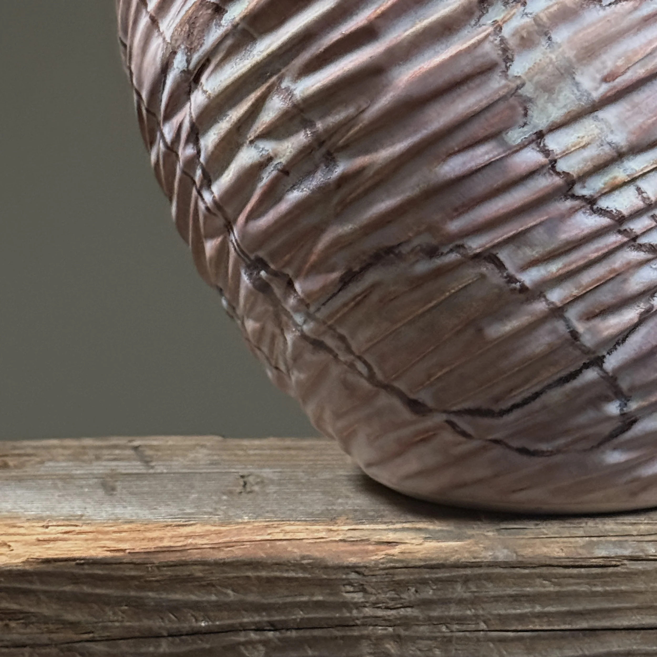Side profile of vintage Japanese ceramic vase showing ribbed abstract surface