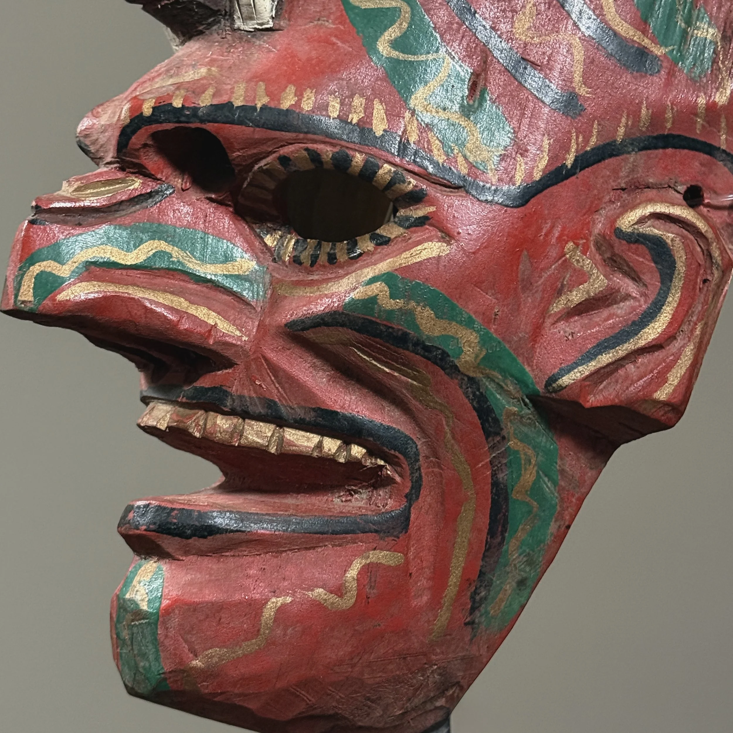 Detail of the painted polychrome surface and facial expression.