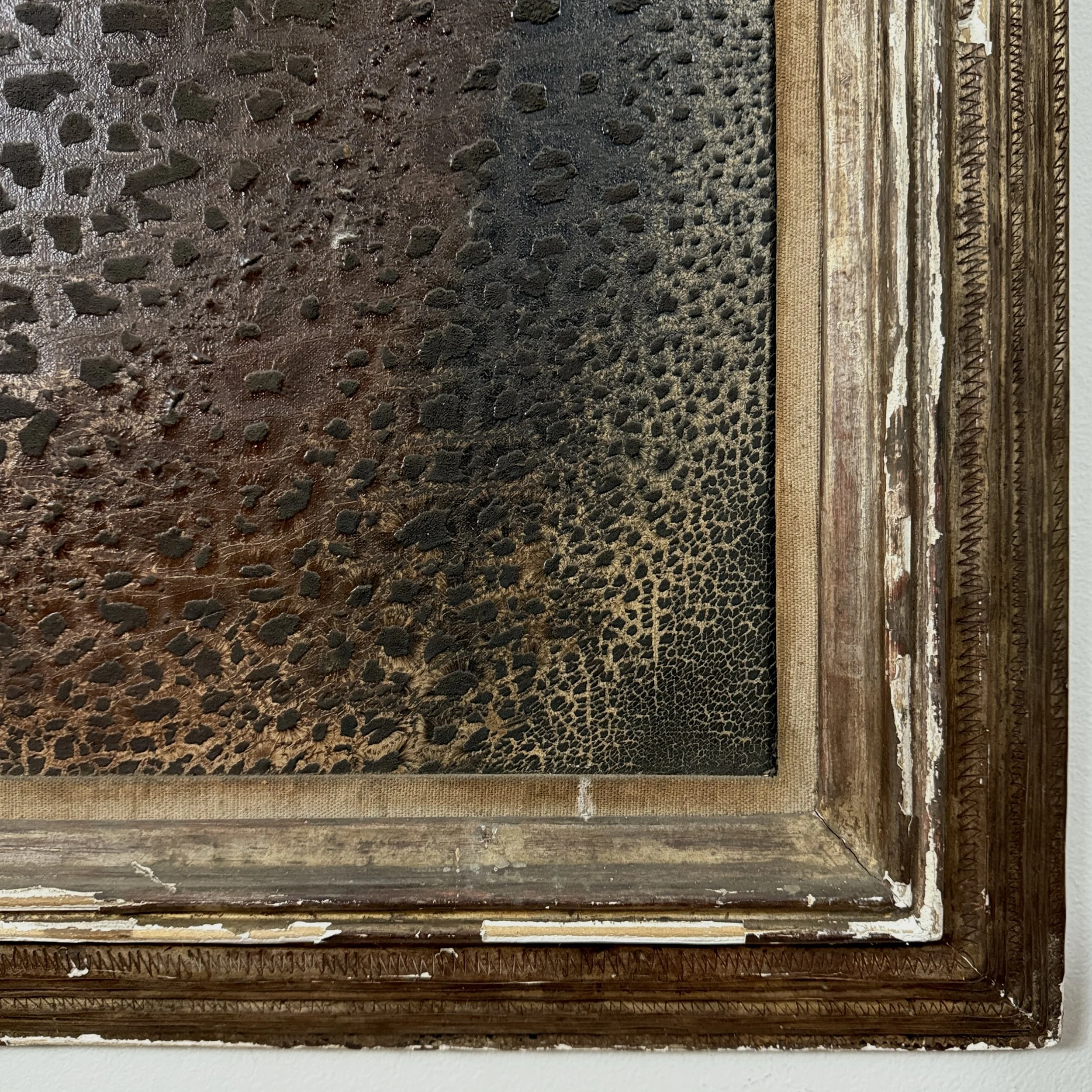 Detail of the frame's corner, showing carving style and losses.