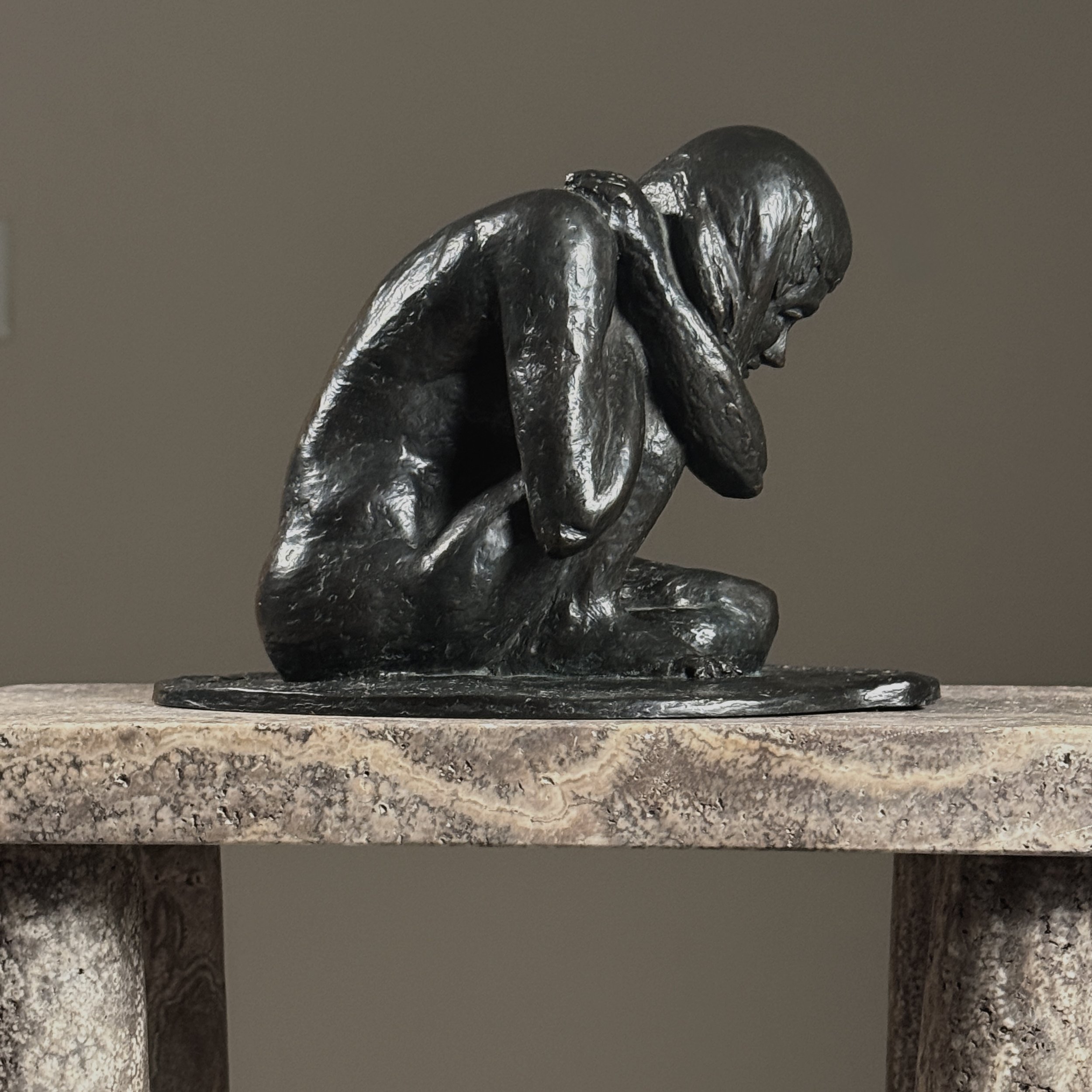 Side profile of a vintage bronze crouching nude sculpture by American artist Alma Helbig Hobson