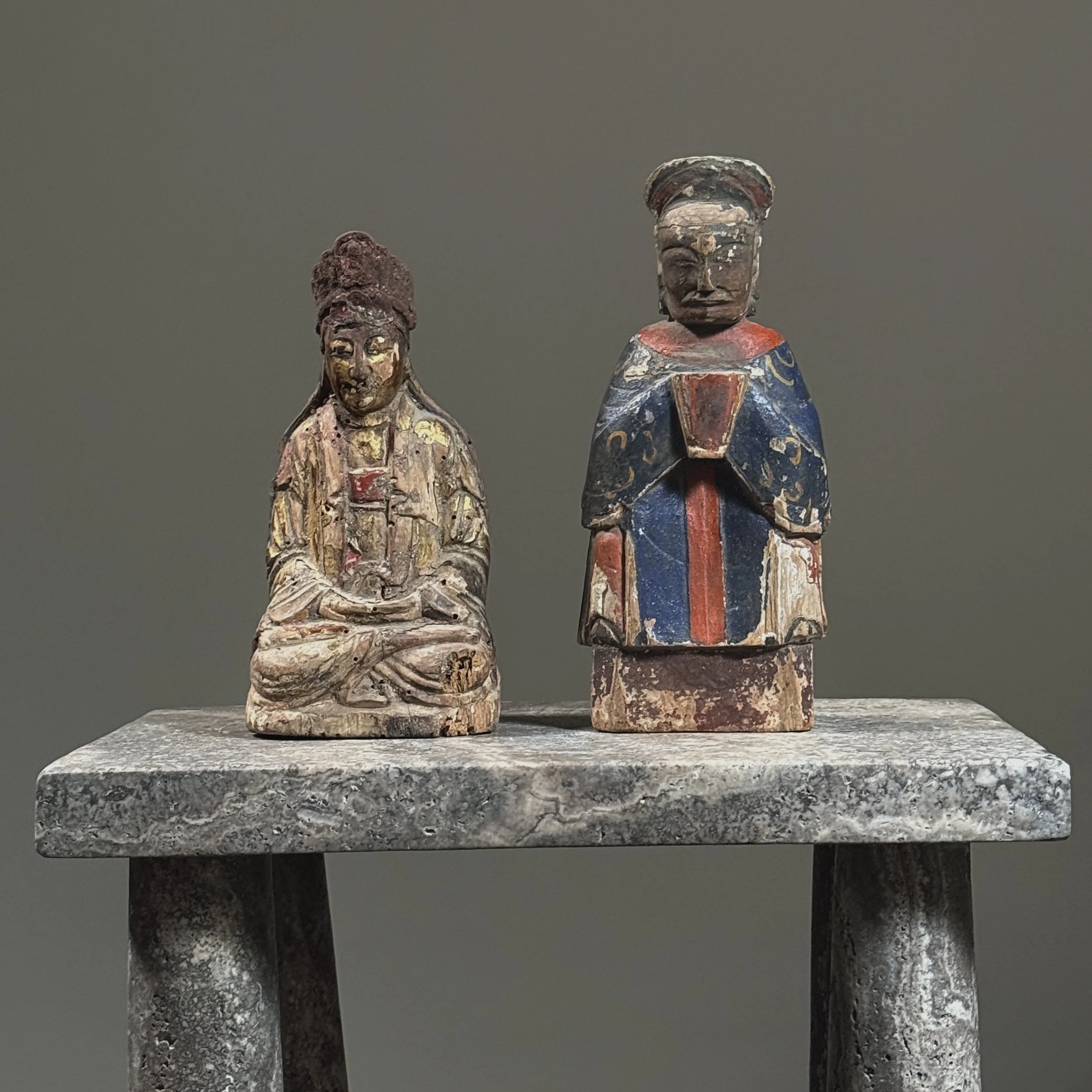 Two deities on marble stand.