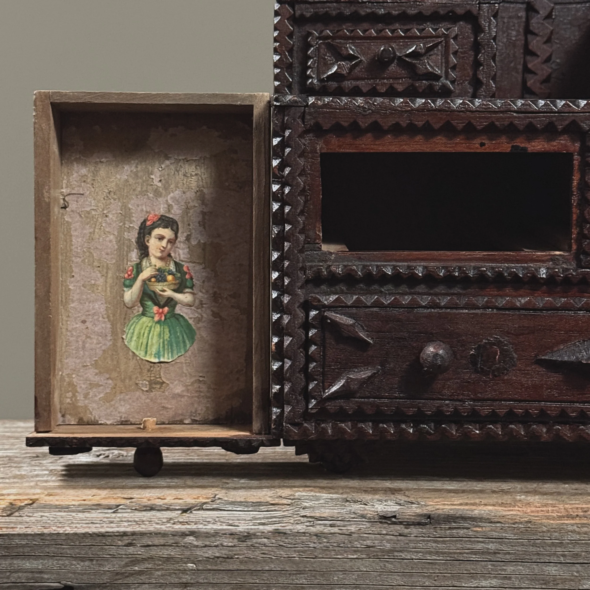 Interior view of large bottom drawer with decoupage elements visible