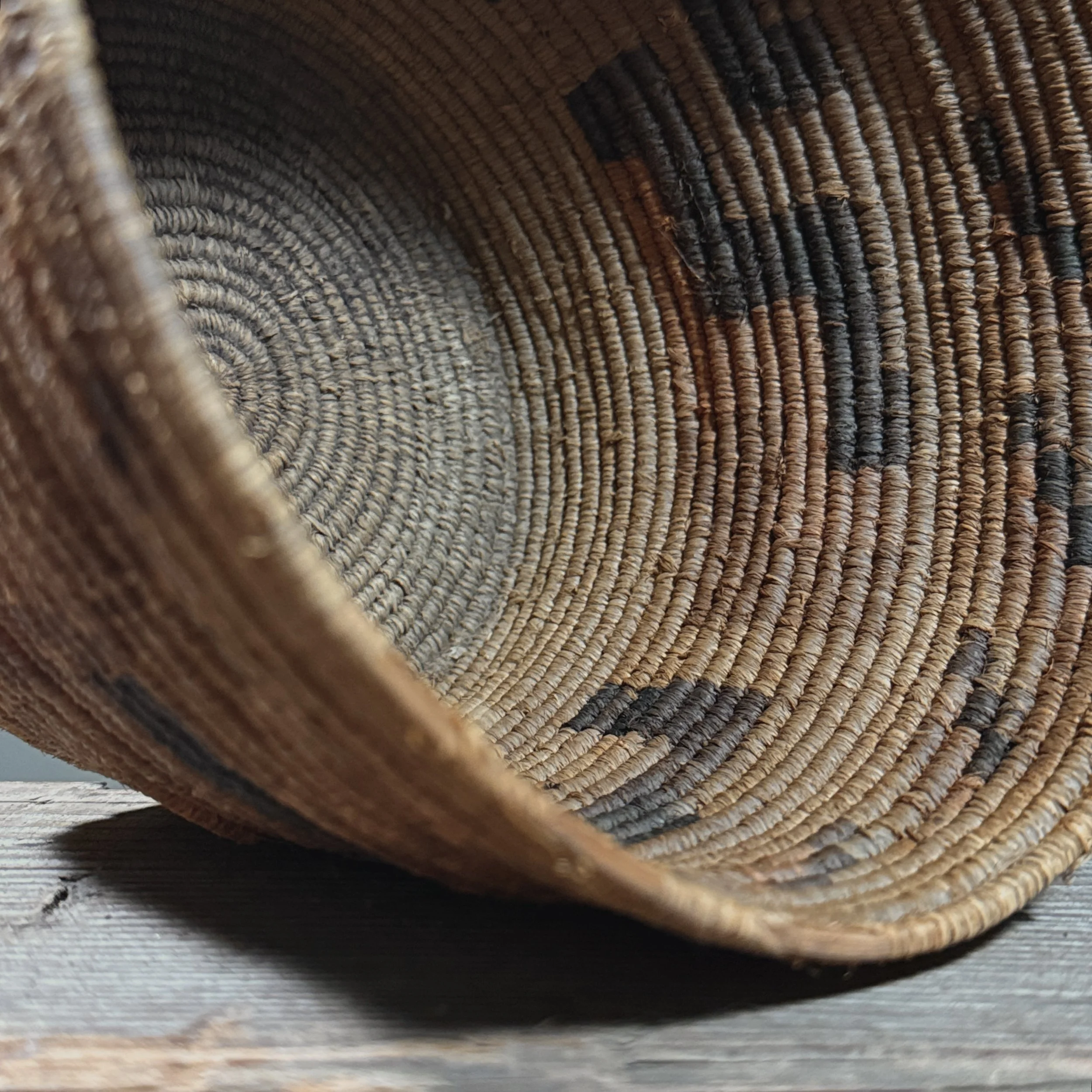 Close-up detail of the step pattern executed in dark devil's claw against a light yucca background