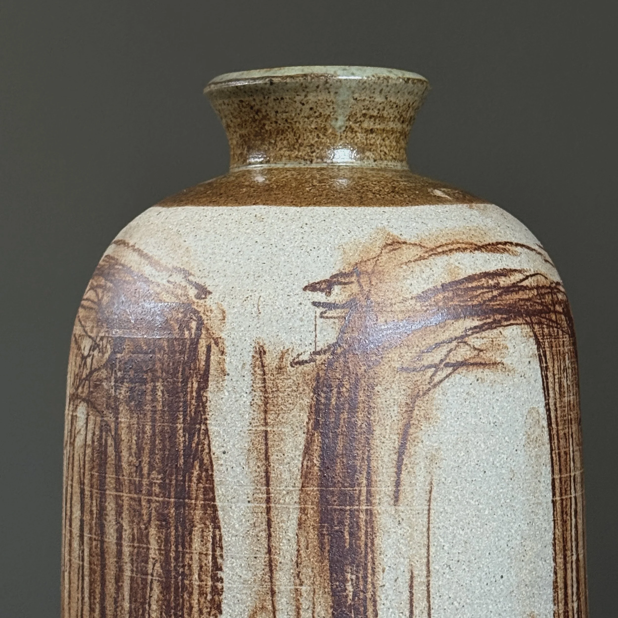 Close-up of brown abstract markings on vintage ceramic