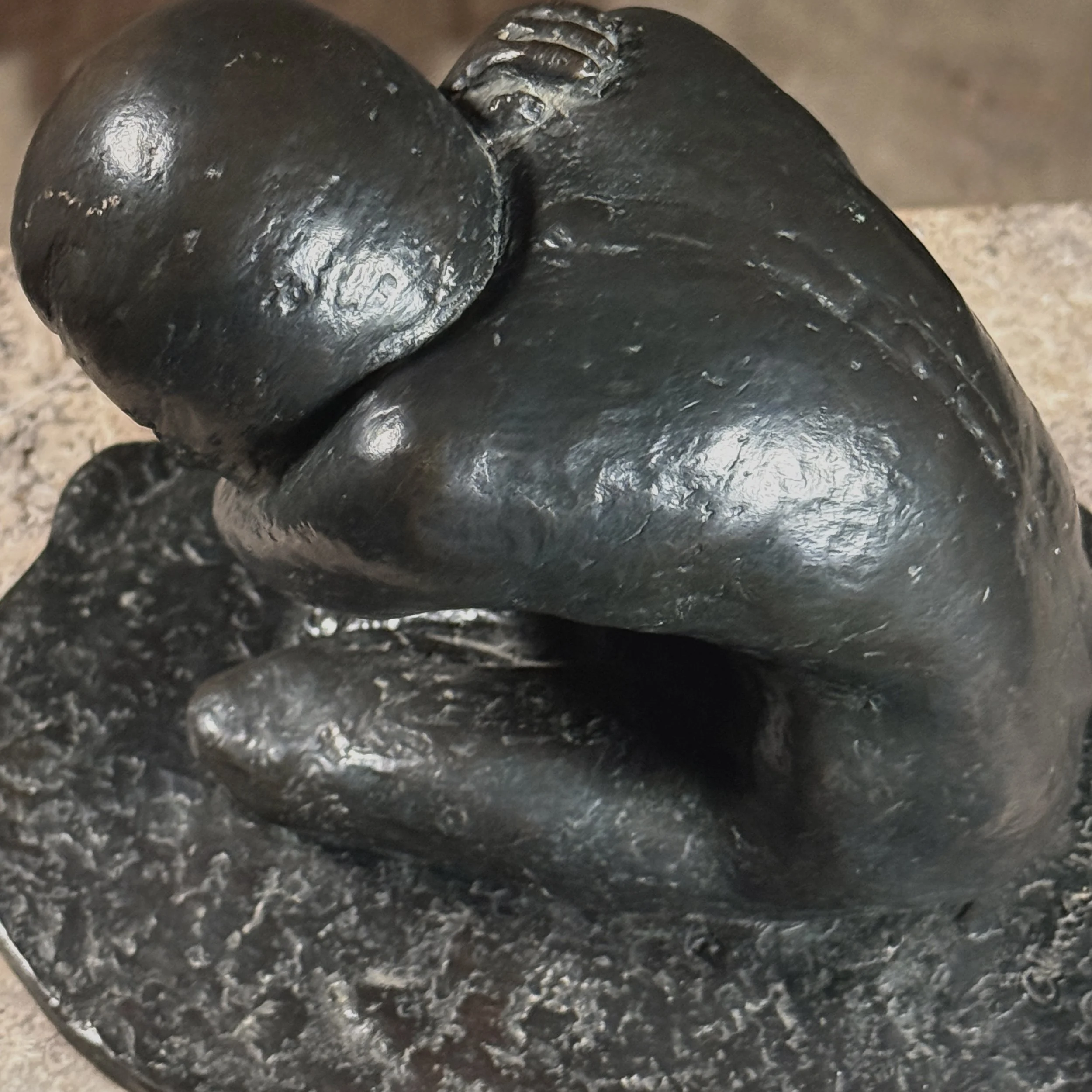 Elevated view looking down onto a crouching nude bronze by Alma Helbig Hobson
