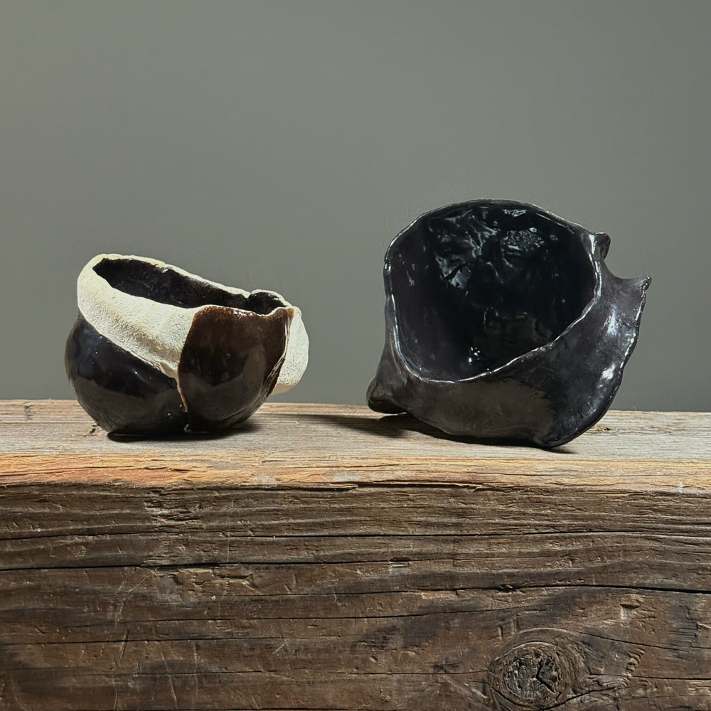 Vintage Abstract Modernist coffee cup and glossy black vessel. Signed. Largest: 3.25 inches height by 5 inches width.