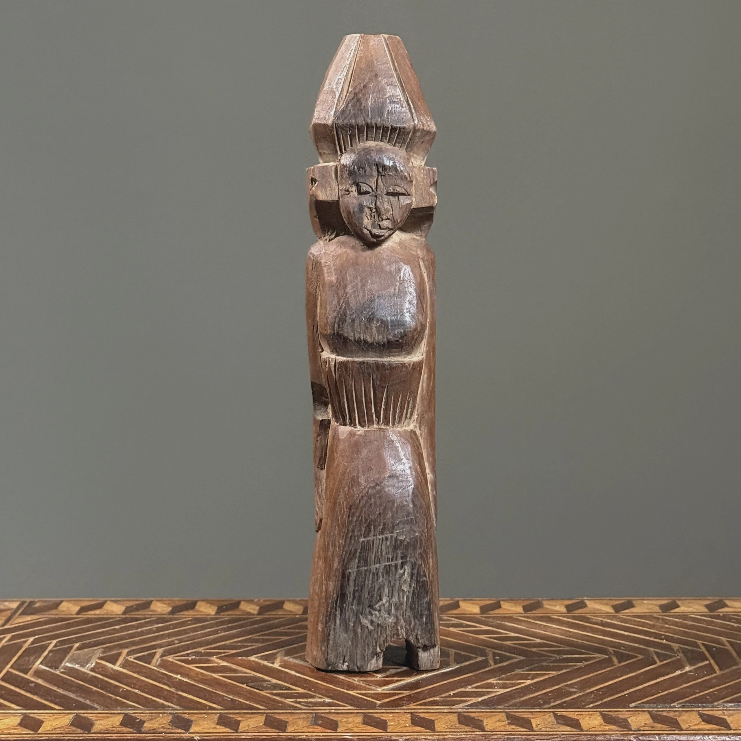 Flat-backed brown wooden female figure from Southeast Asia