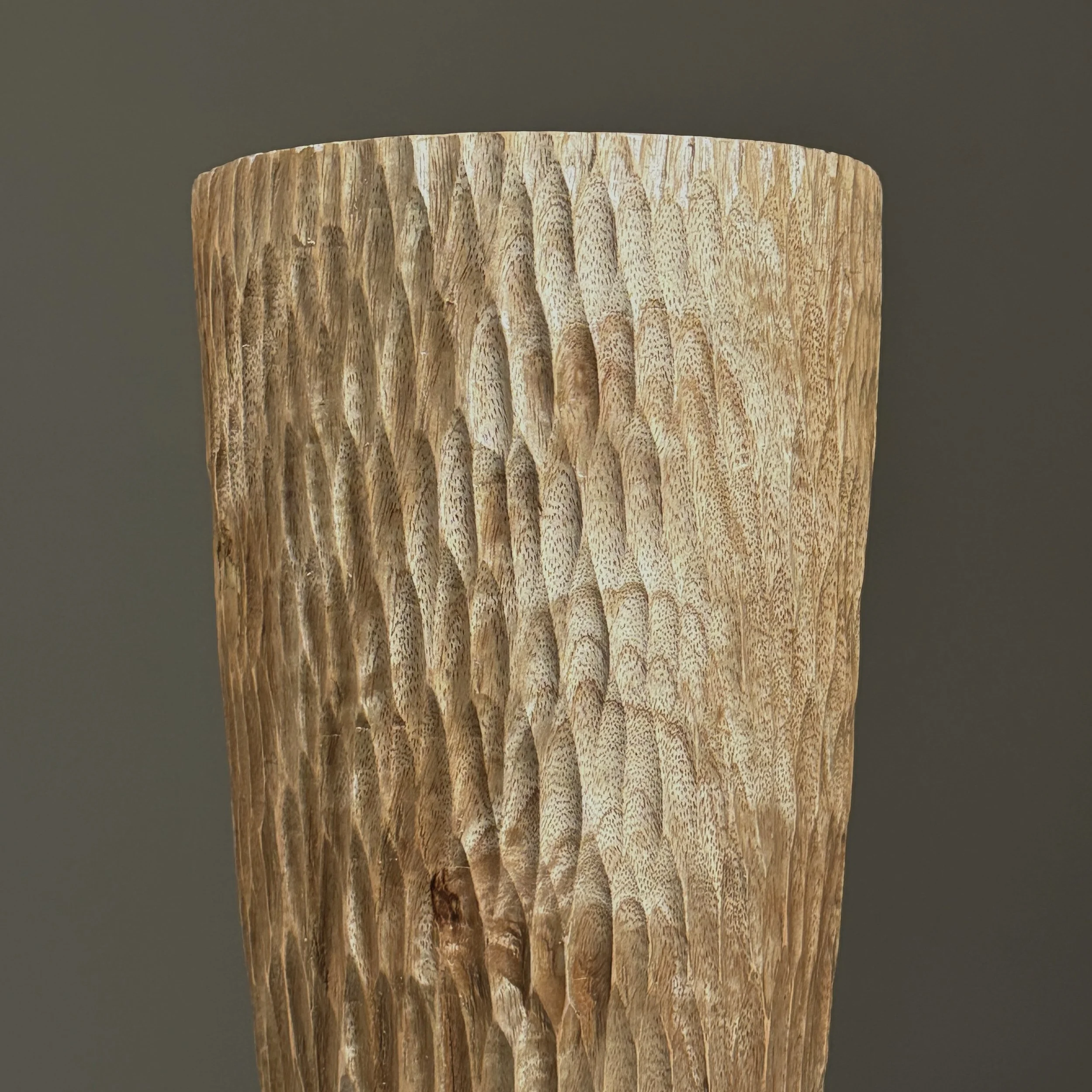 Detail of the chip-carved geometric pattern on the surface.