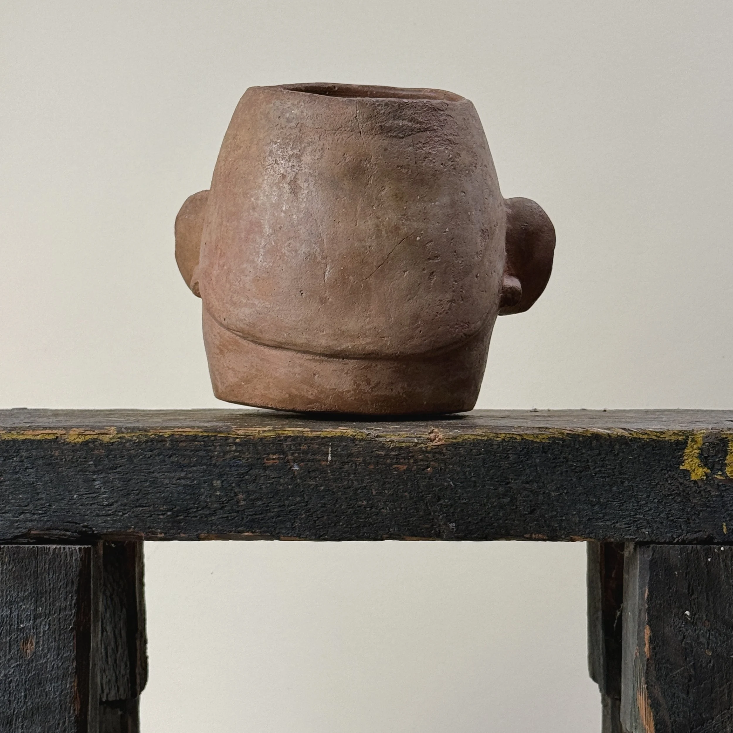 Back view of Pre-Columbian Moche portrait head vessel with facial paralysis and tumor