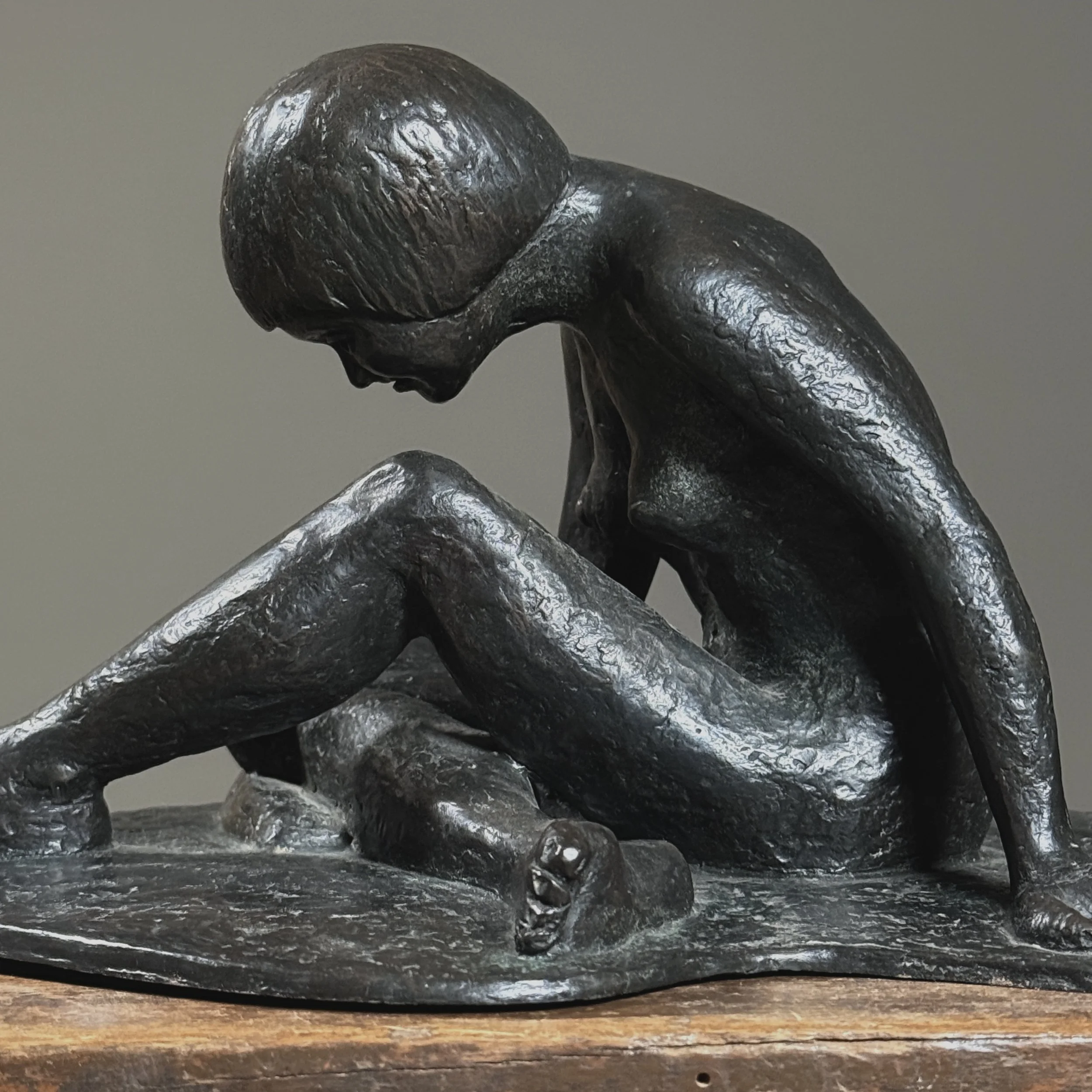 Side profile of sculpture. Expressive bronze modeling visible. 8.5 inches depth.