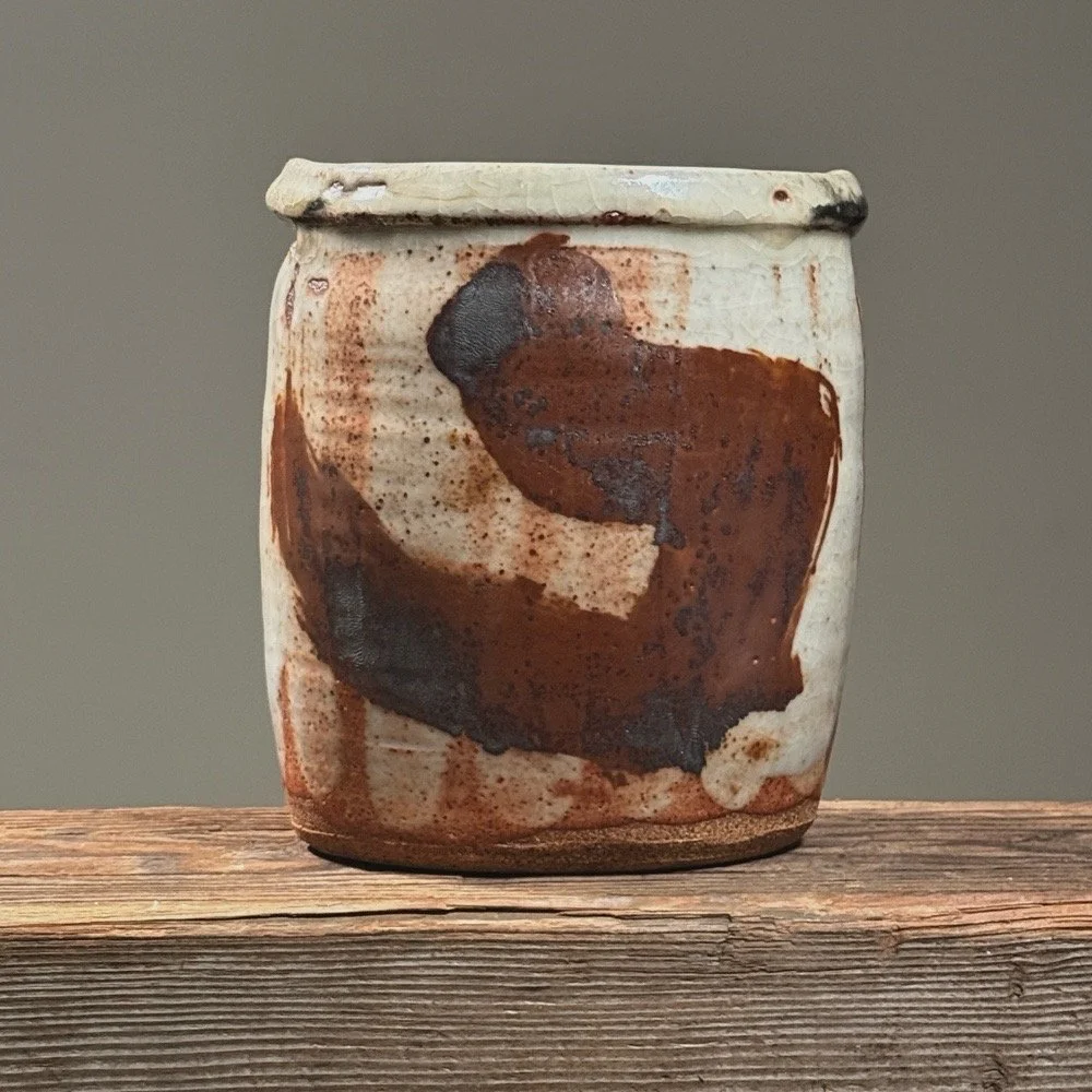 Vintage Japanese Raku fired ceramic vessel on white background. Shino crackle glaze visible.