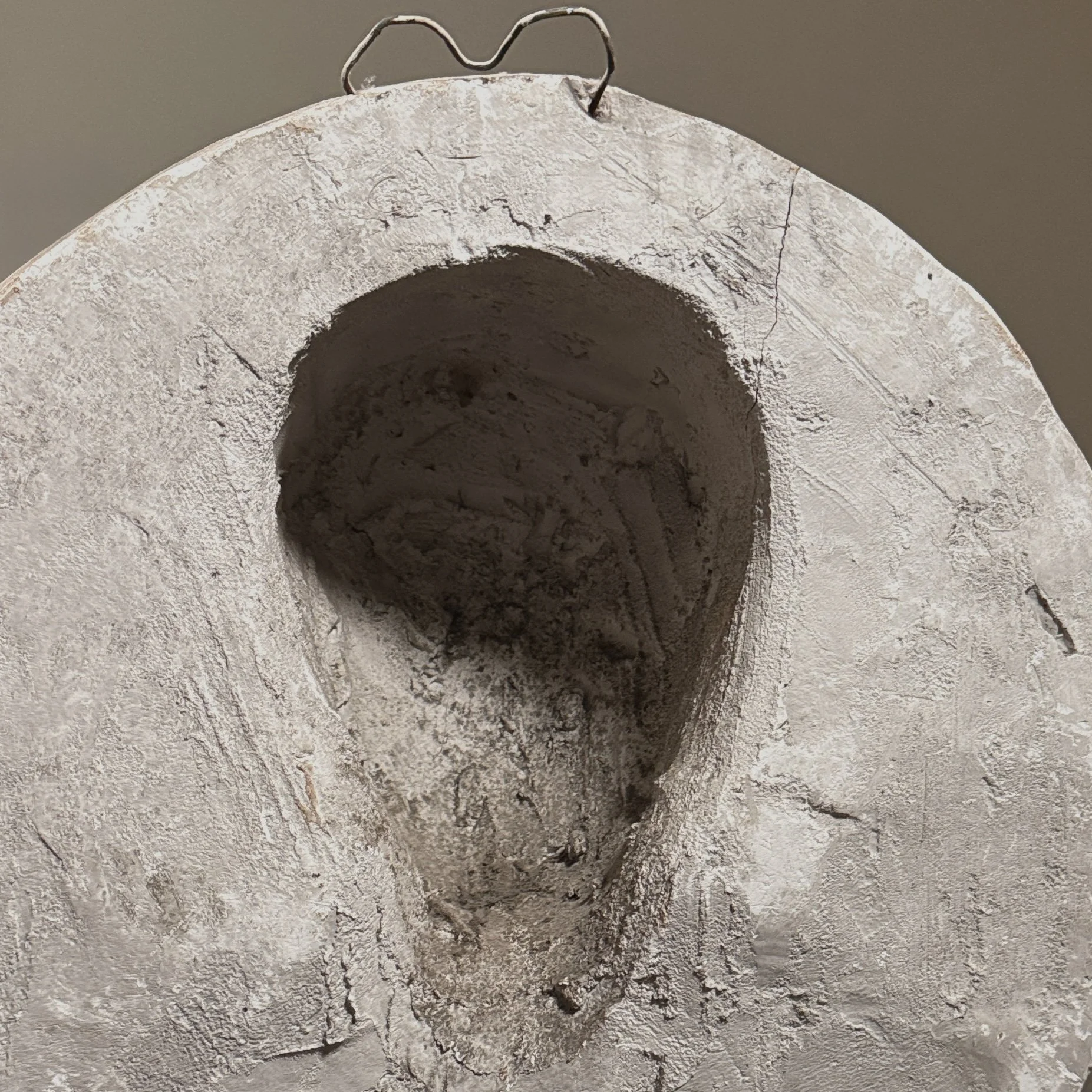 Detail of the reverse, showing the flat back and possible hanging hardware.