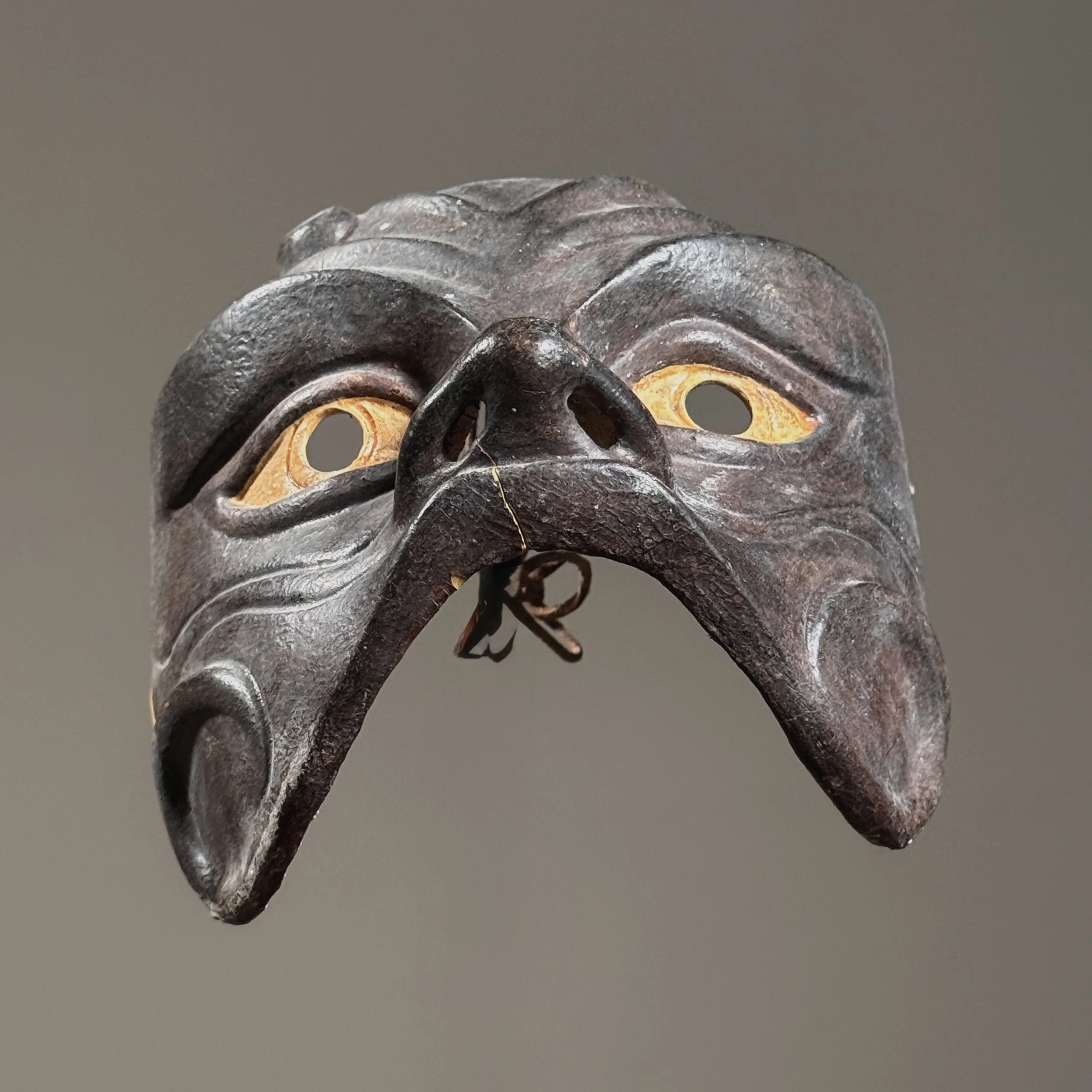 Modernist interpretation of Commedia dell’arte mask in brown leather over sculpted form.
