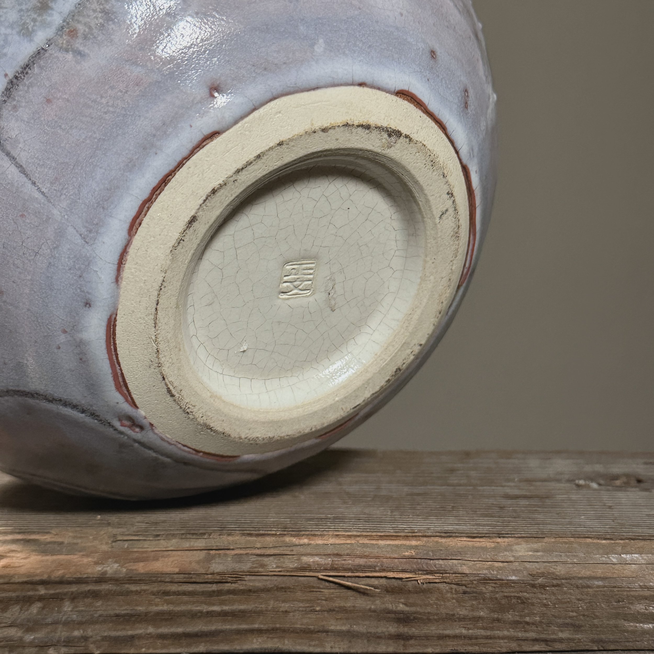 View of the base showing the artist's signature or stamp.